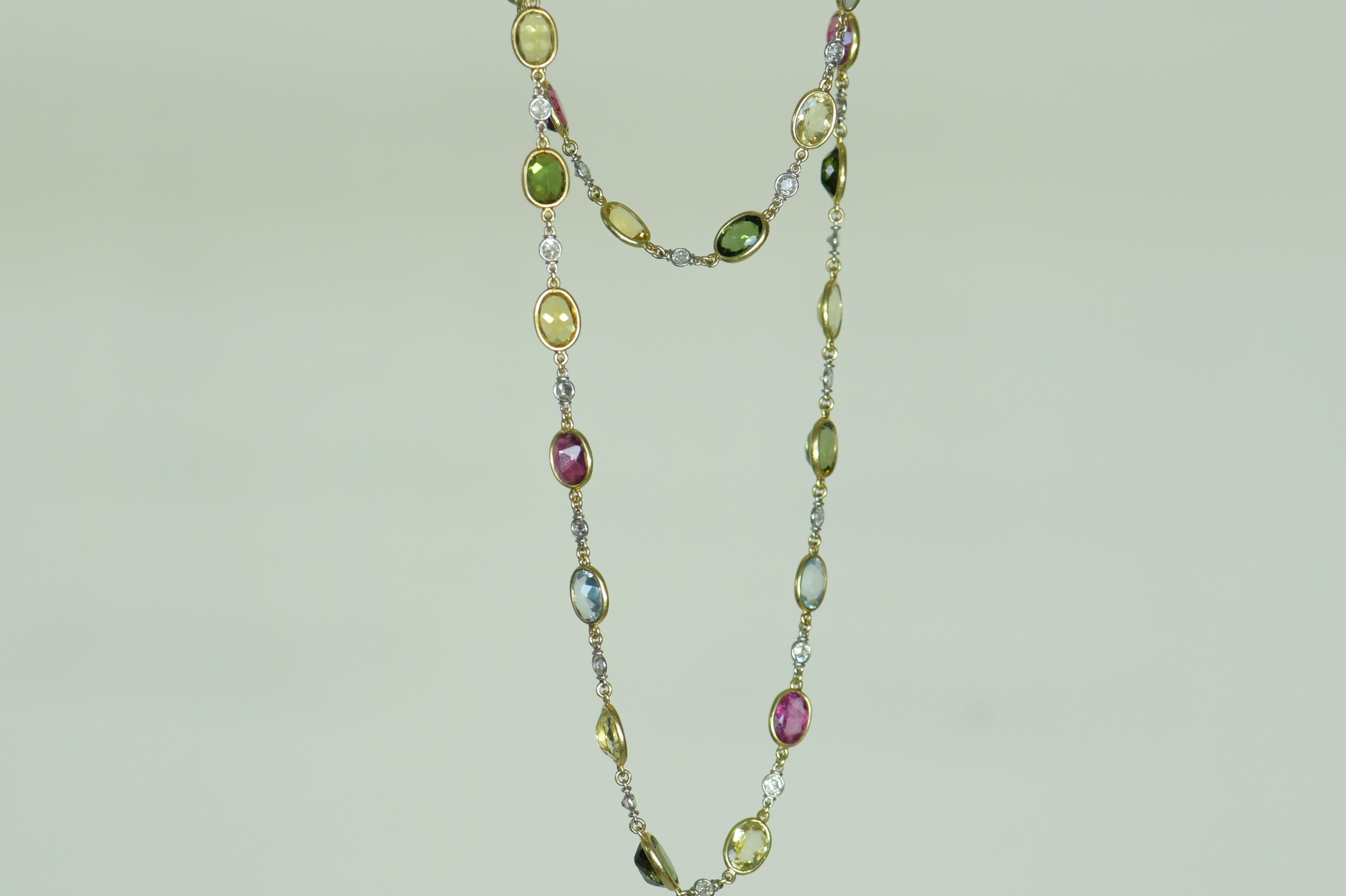 A very elegant Edwardian yellow gold necklace contains 29.50 ct of peridot, citrine, yellow sapphire, aquamarine, tourmaline, and diamonds. The rainbow of colors makes this necklace versatile for an array of occasions and would be perfect for