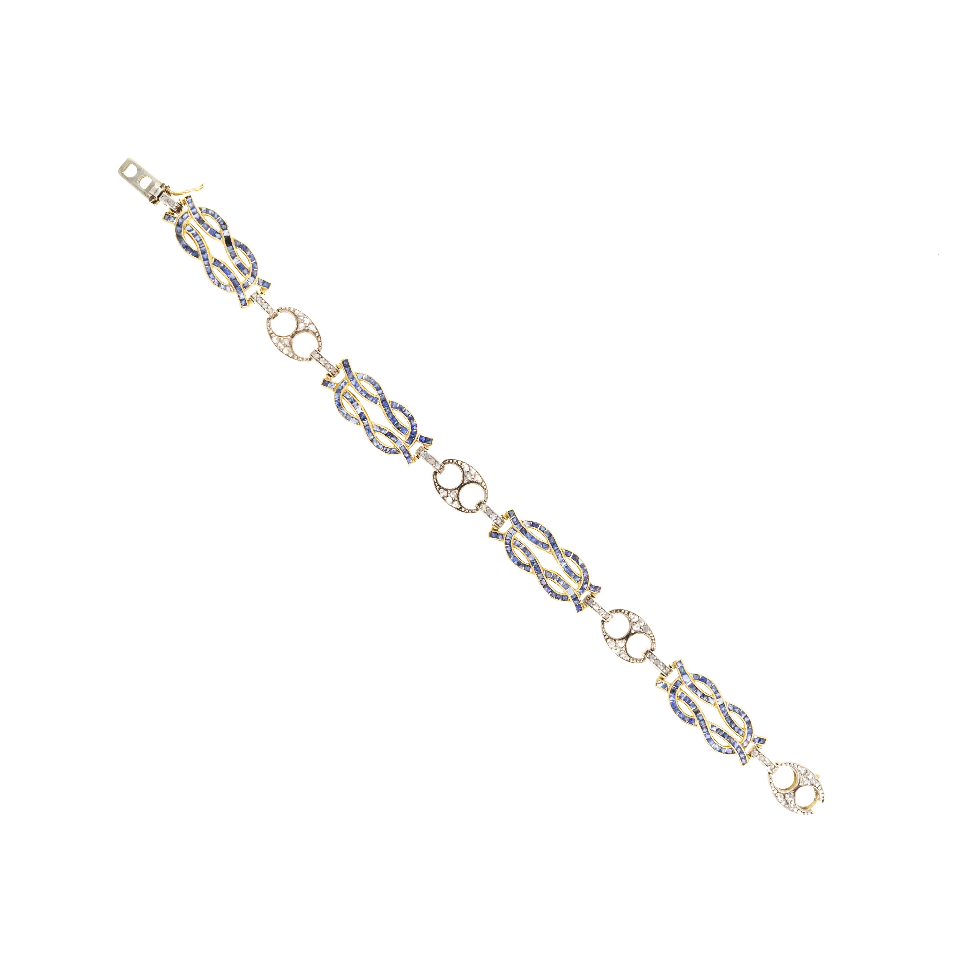 Era: Edwardian Estate

Composition: 18K Yellow Gold & Sterling Silver

Primary Stones: Natural French Cut Sapphires

Total Carat Weight: Approximately 5 Carats

Accent Stones: Rose Cut Diamonds

Total Carat Weight: Approximately 0.65
