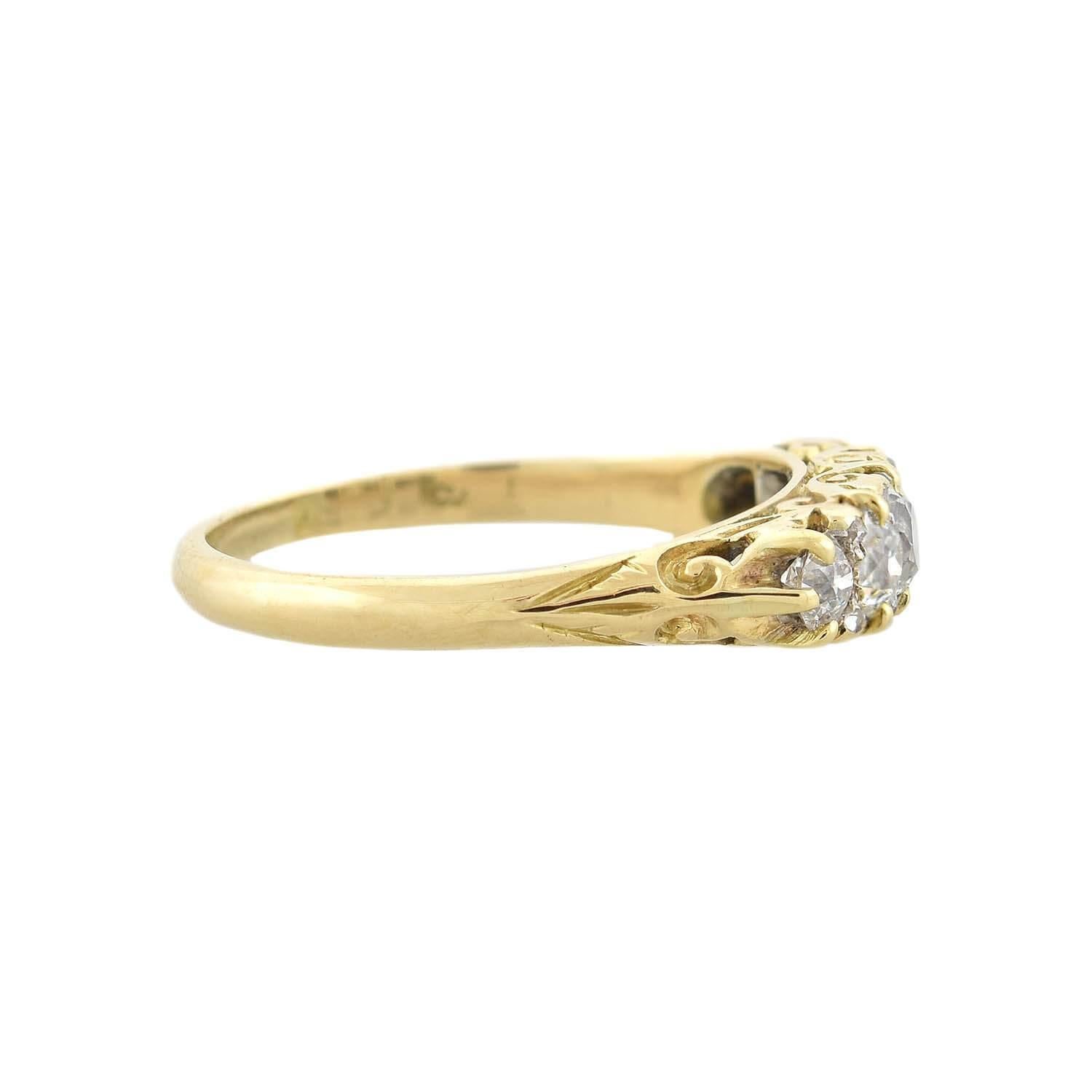 A gorgeous Edwardian (ca1910s) era diamond ring! Crafted in 18kt yellow gold, this stunning piece has a beautiful 5-stone design. Lining the face of the ring is a row of gently graduated old Mine Cut diamonds. Eight small Rose Cut diamonds adorn the