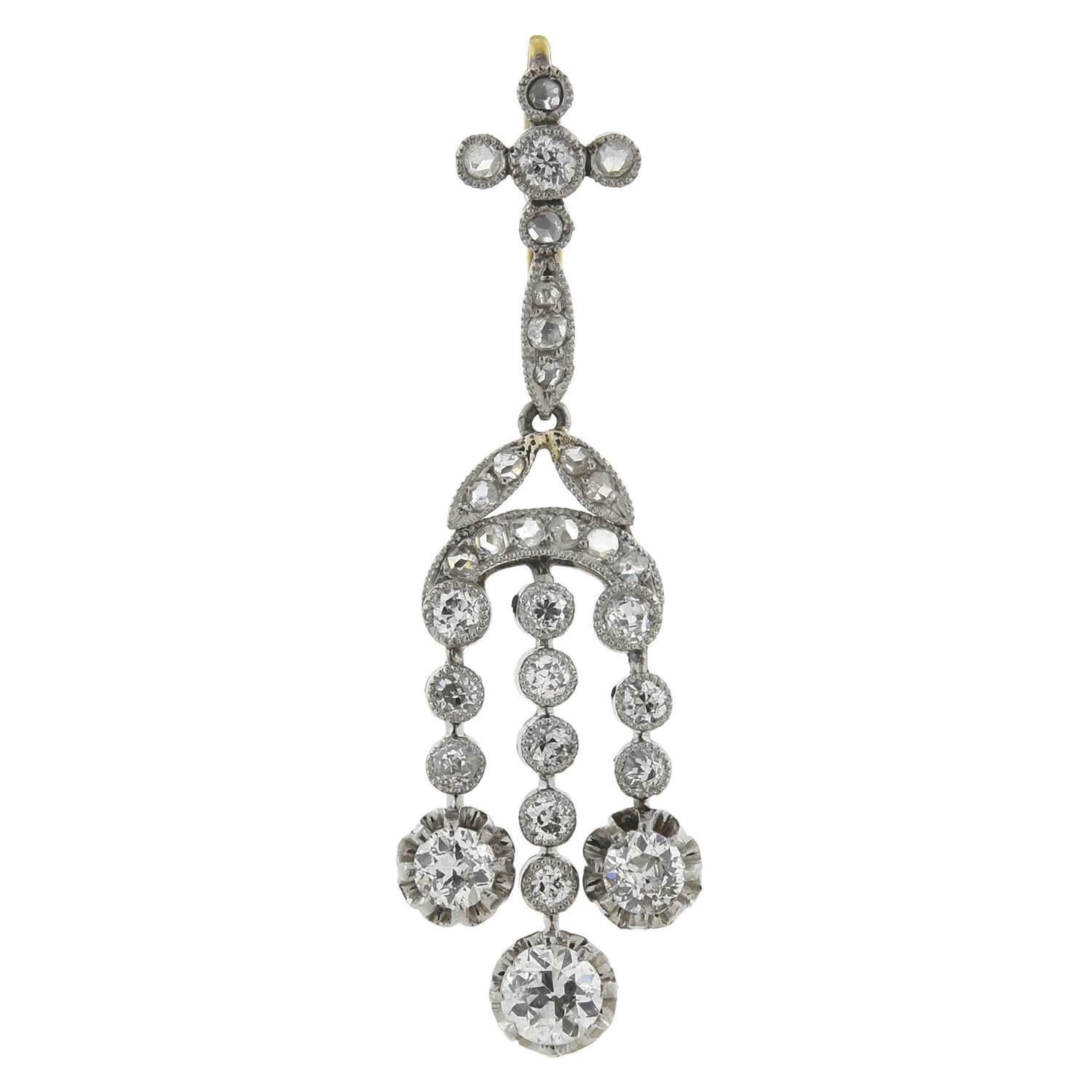 An exquisite pair of dramatic diamond earrings from the Edwardian (ca1915) era! Each earring is crafted in platinum with yellow gold wires and displays a feminine chandelier design. A stunning combination of sparkling old Rose and Mine Cut diamonds