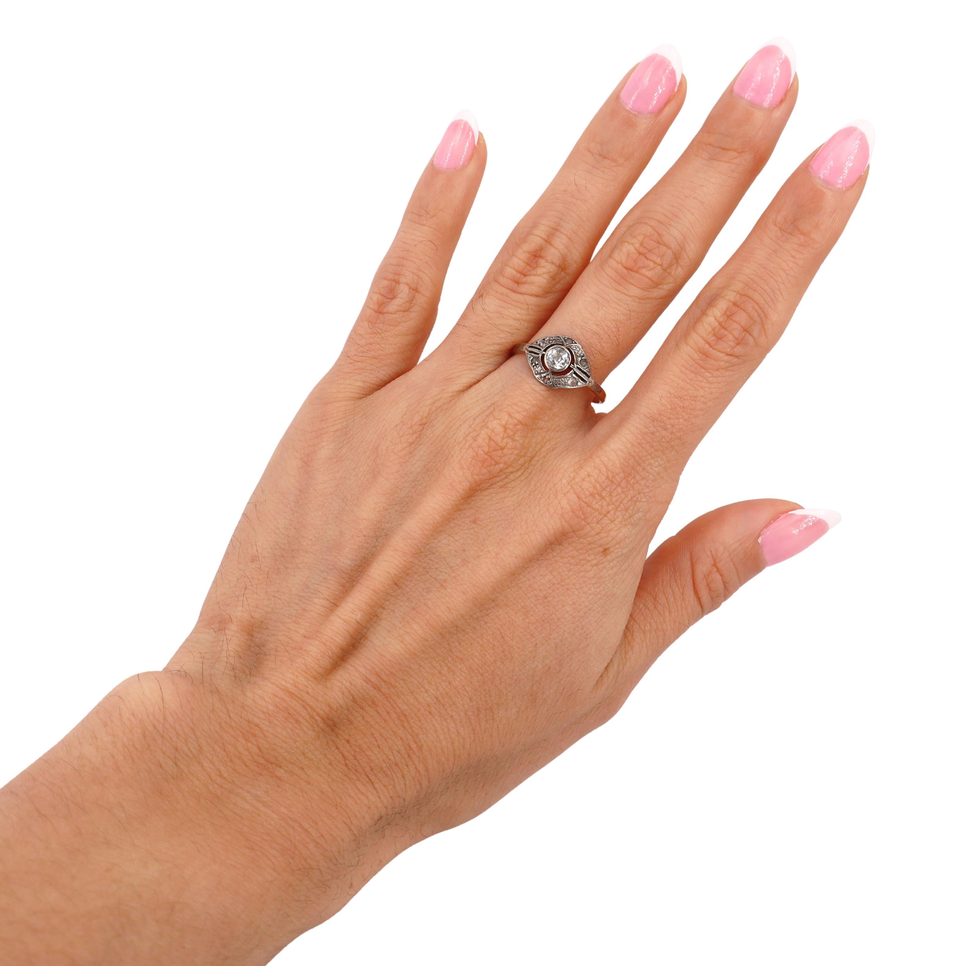 This exquisite Edwardian engagement ring, dating to the early 20th century, reflects the elegance and intricacy of the Edwardian era. Crafted in 18kt yellow gold with a platinum top, it exudes timeless sophistication and meticulous