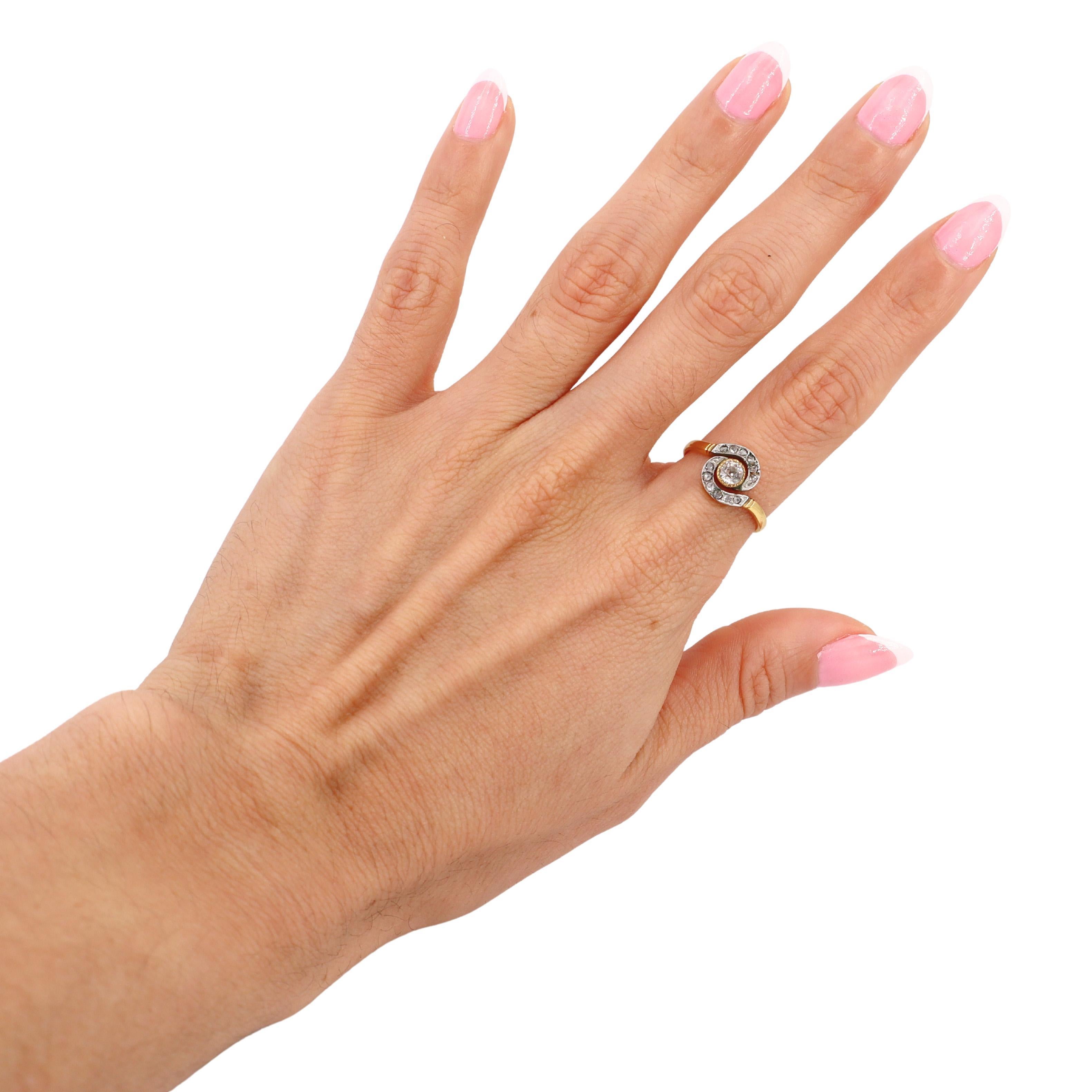 This elegant Edwardian engagement ring, crafted in the early 1900s, is a timeless representation of the era's romantic and intricate design. Made from 18kt yellow gold with a platinum top, it reflects the luxurious craftsmanship and attention to