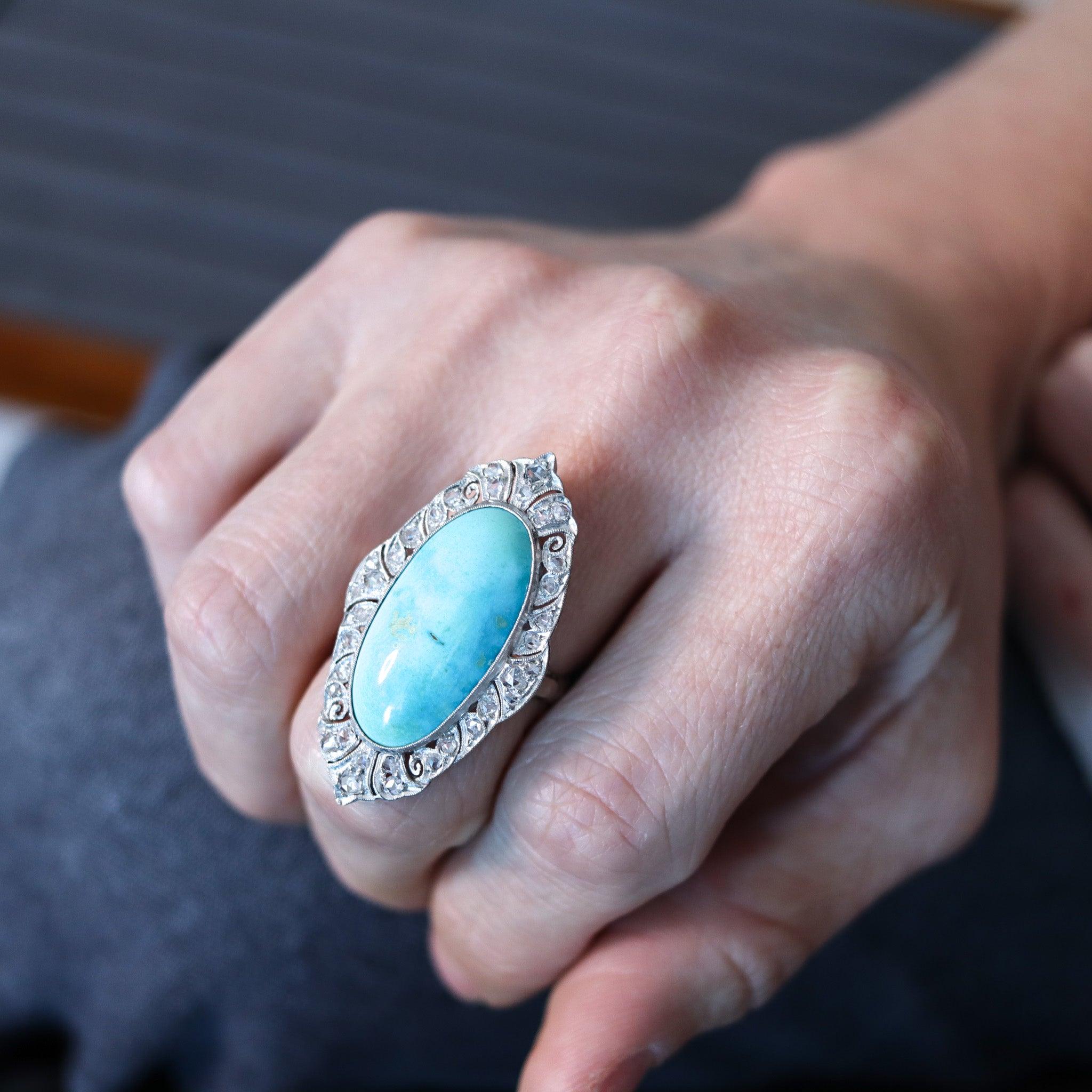 Edwardian cocktail ring with American turquoise.

This is a stunning large cocktail ring created in America during the Edwardian period, back in 1900's. The ring has been crafted with transitional styles in solid .900/.999 platinum and 18 karats