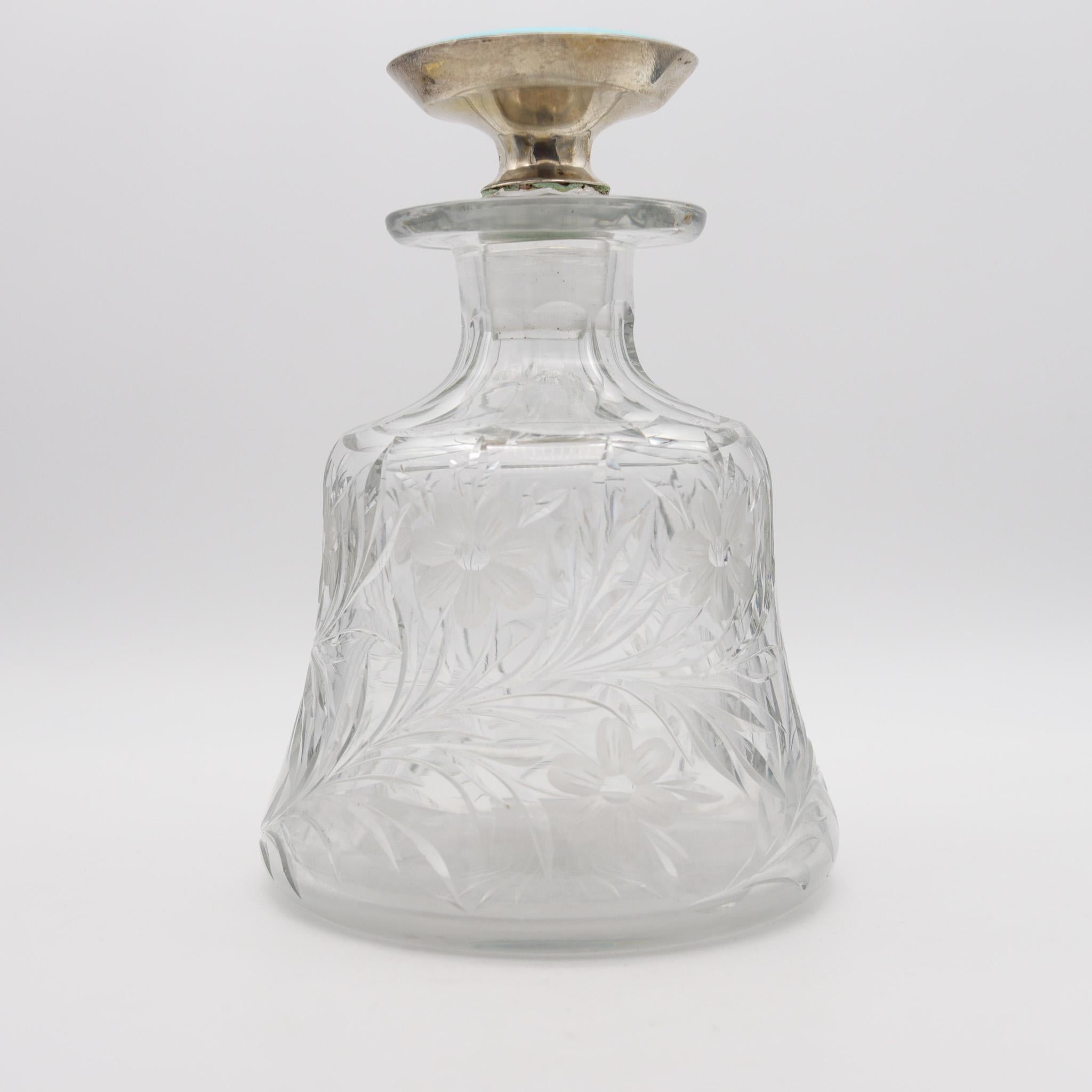 Guilloché enamel perfume bottle in cut glass.

Beautiful and very decorative antique perfume bottle, created during the belle Epoque-Edwardian period, back in the beginning of the 20th century, circa 1905. This bottle has been crafted in very fine