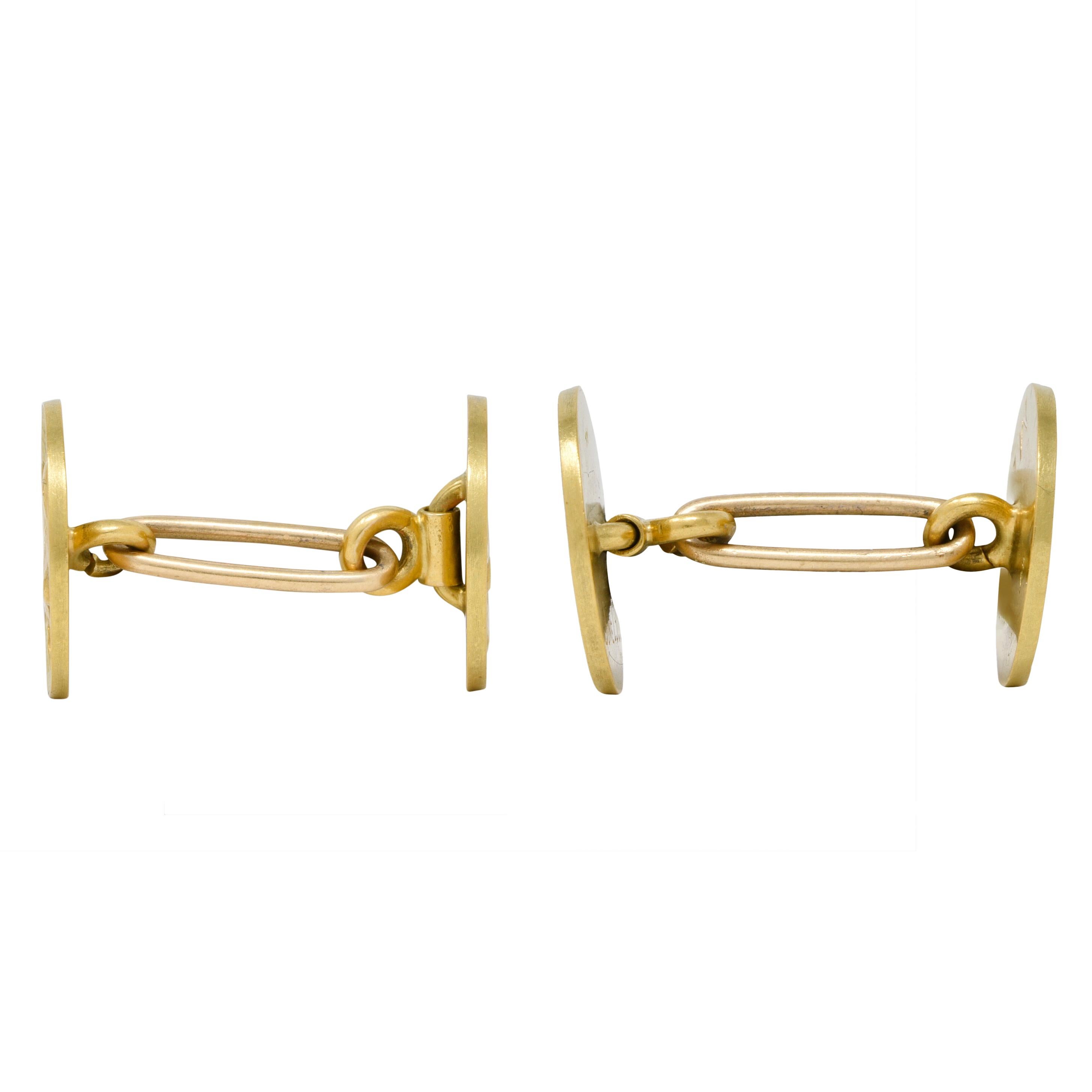 Designed as green gold link style cufflinks terminating with round faces centering raised cameos
Depicting portraits of highly rendered yellow gold horses 
With a textured background of trees and grass
Connected via an oval link
Inscribed 'June 1908