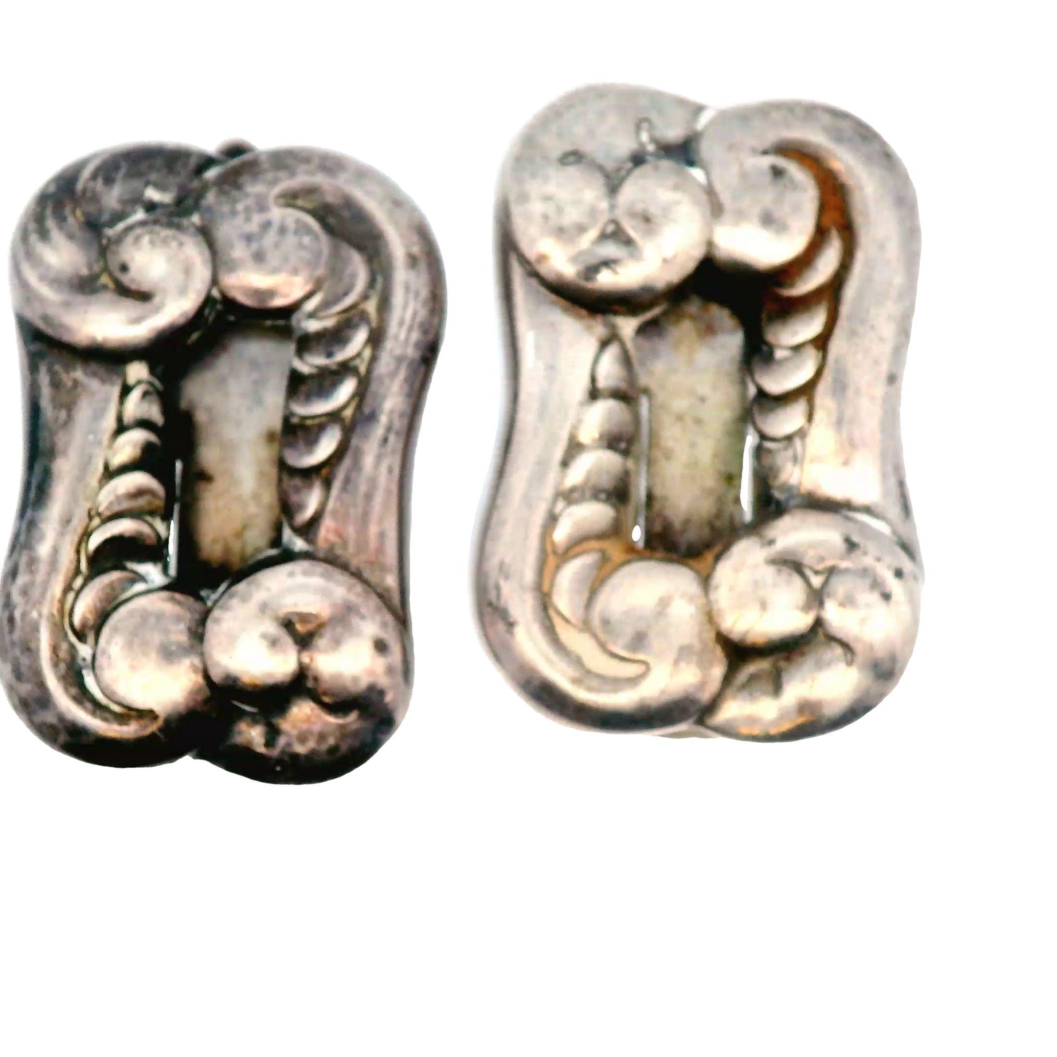 This lovely pair of sterling silver clip pins were made by the renowned Danish Georg Jenson in 1910 Edwardian period. These clips are in great condition for their age, both aesthetically and functionally. The clips are in excellent working