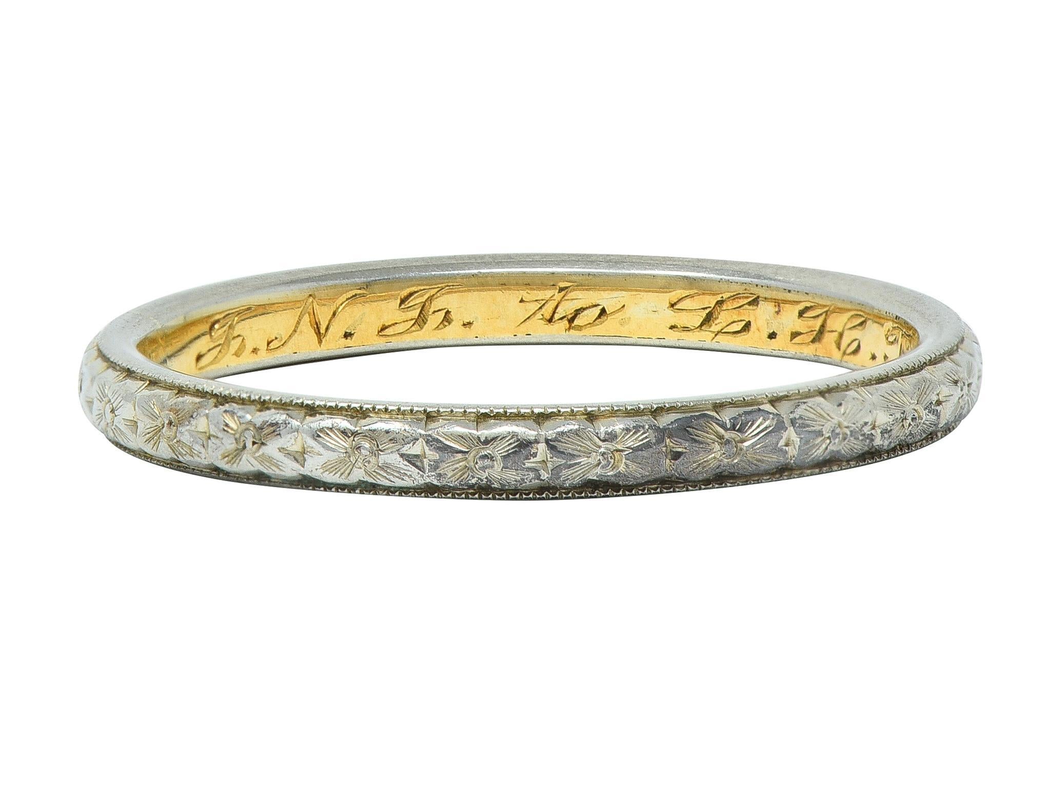 Band ring features an engraved white gold orange blossom motif fully around 
Accented by milgrain edges - with yellow gold inner shank
Inscribed 'J. N. J. to L. H. T. June 22 1911' 
Tested as 18 karat gold
Circa: 1911; via dated inscription
Ring