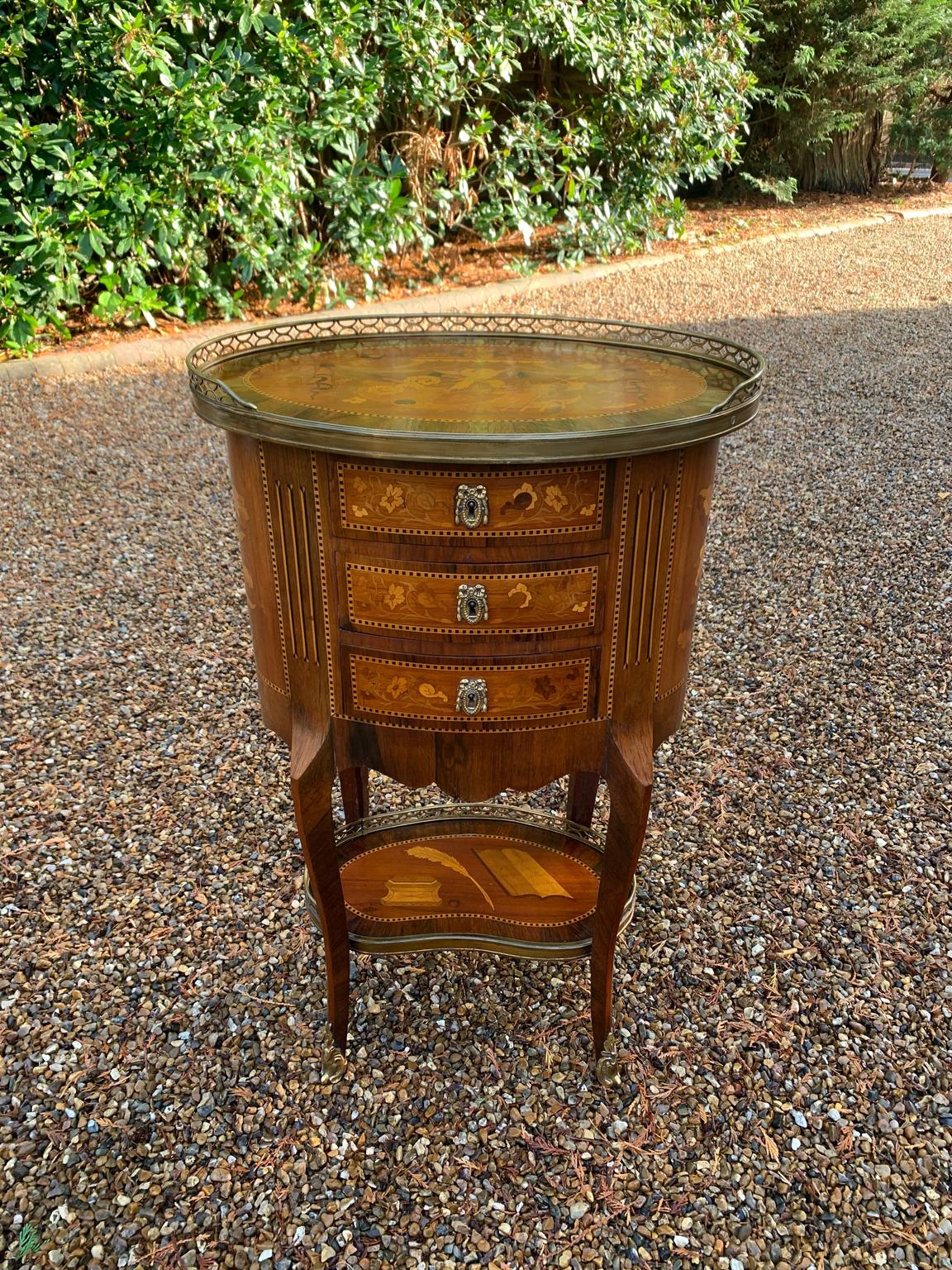 A Edwardian / 1920’s French Kingwood oval table with rosewood, marquetry inlay throughout and brass gallery. Above three fitted drawers and gilt metal mounts. Also fitted with a protective oval glass top, shown in picture two. 
Circa: 1900 /