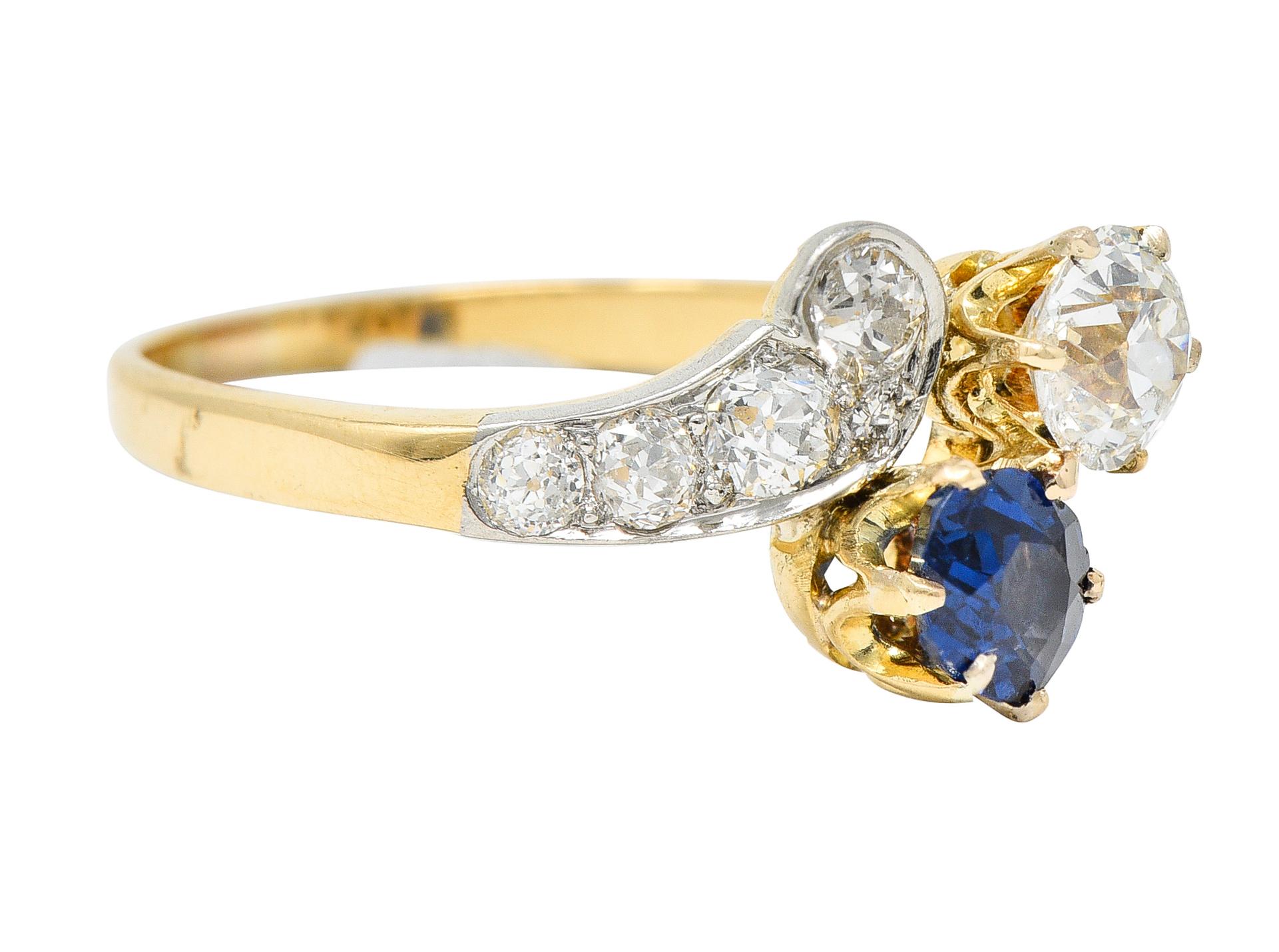 Bypass ring centers two gemstones in the Toi et Moi style - French to mean 'You and Me'

One being an oval cut sapphire weighing approximately 0.55 carat - vividly royal blue in color

With an old European cut diamond weighing approximately 0.55