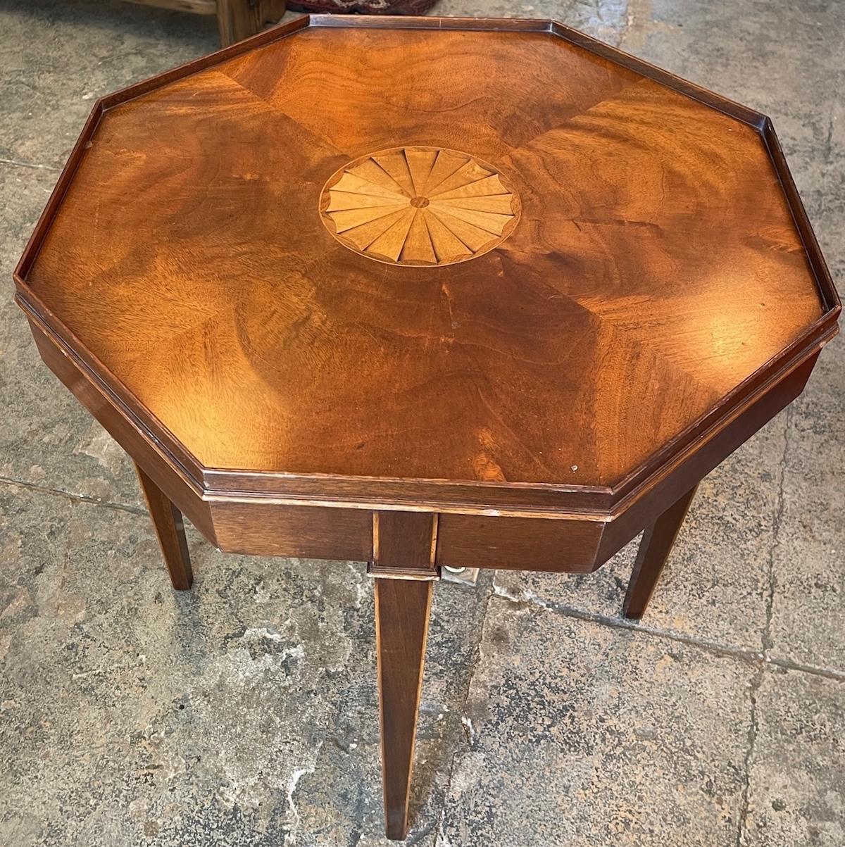 This is a very unique 19th century walnut end table with elaborate centre rosewood inlay. It has a slight raised surround.