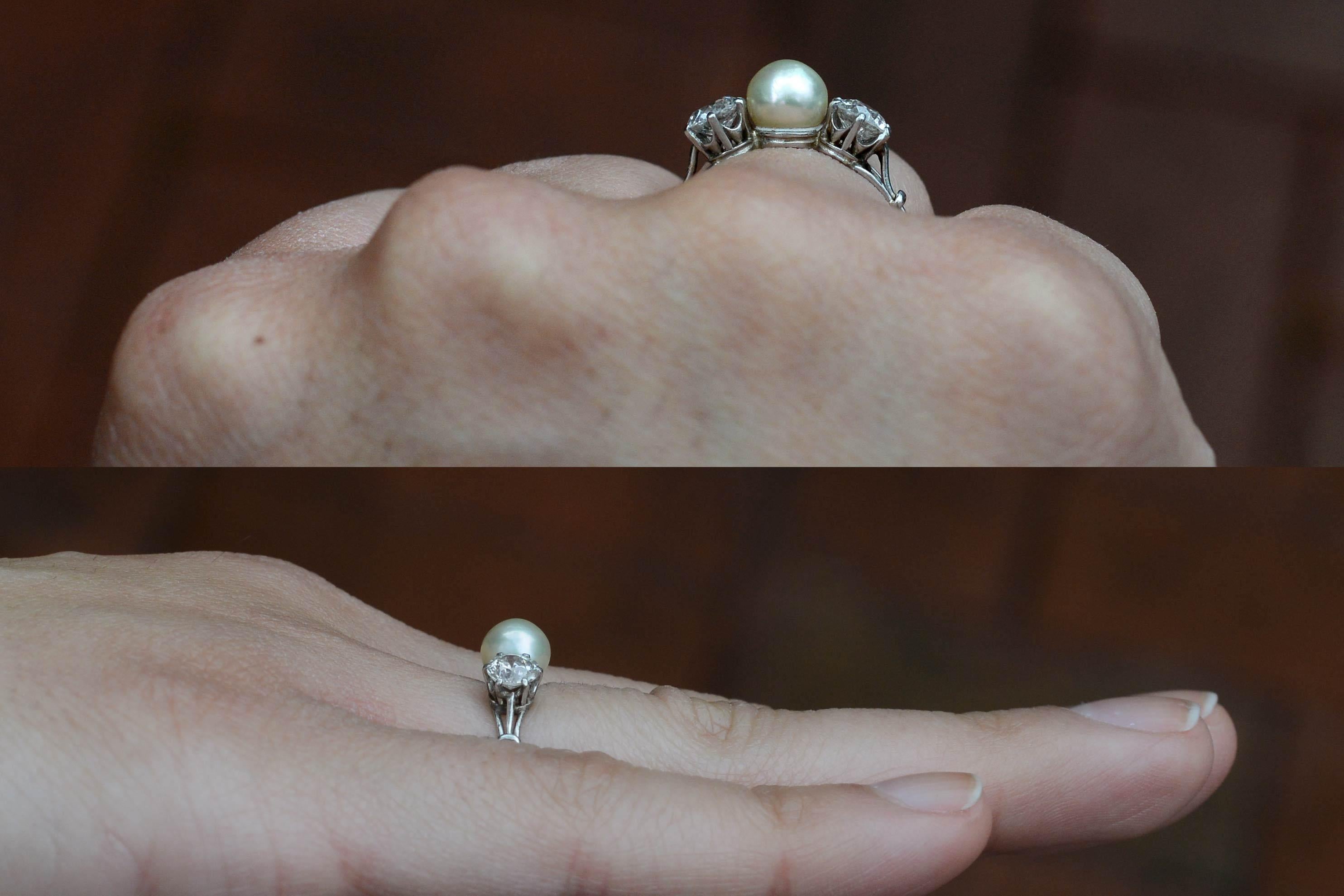 An original Edwardian wedding ring centering on a creamy natural pearl (not cultured!) with the most alluring, glowing, golden luster ever. Embraced by a pair of matching old mine cut diamonds with those chunky facets that glimmer by candlelight and