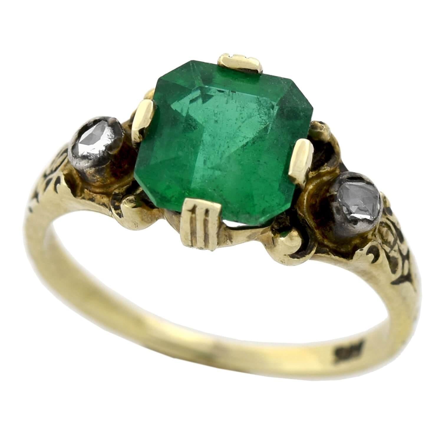 A stunning emerald and diamond ring from the Edwardian (ca1915) era! This incredible piece is crafted in 14kt yellow gold with sterling silver accents and adorns a fabulous Colombian emerald at the center. The Emerald Square Cut gemstone weighs