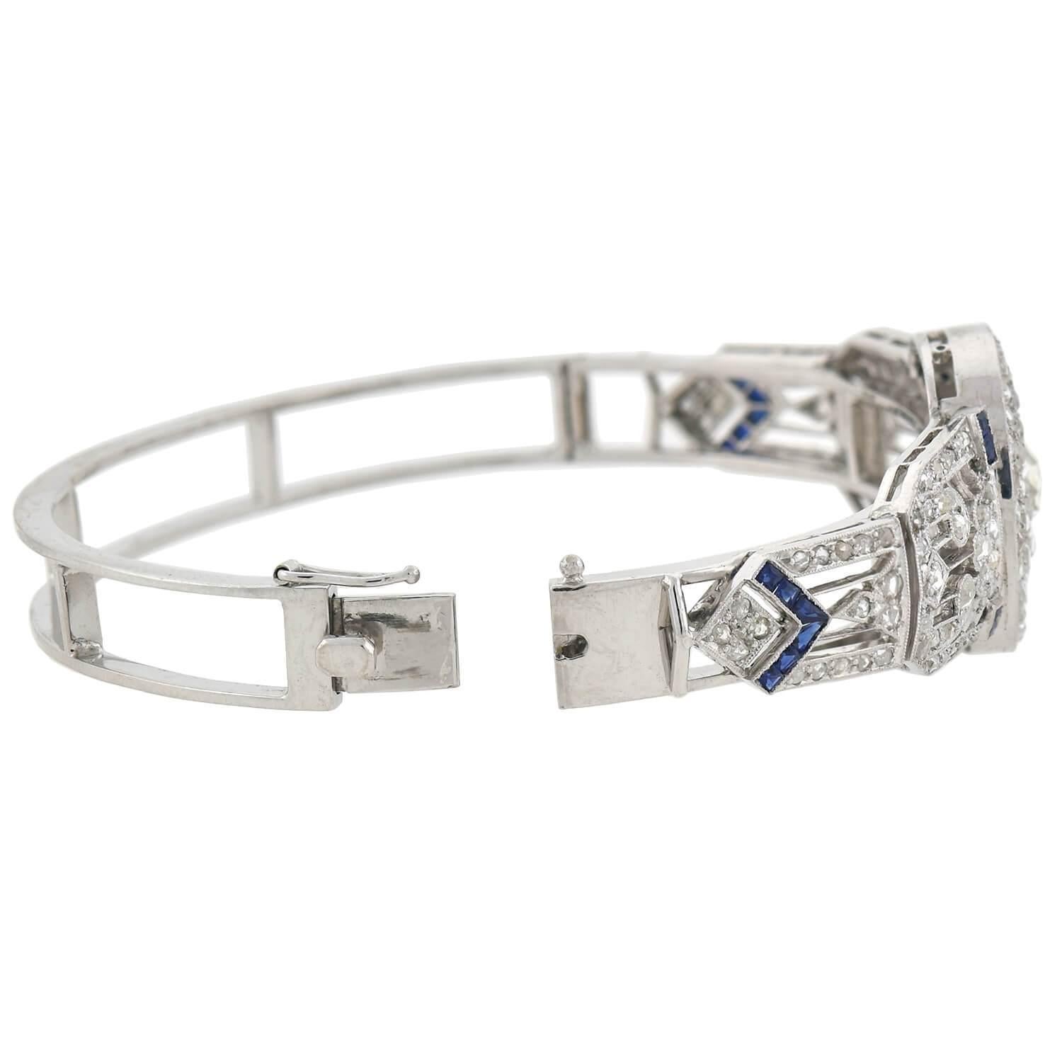 An exquisite diamond and sapphire bracelet from the Edwardian (ca1910) era! This gorgeous and unique platinum piece was once a flexible link bracelet that has since been converted to a fabulous hinged bangle. A sparkling array of old Rose Cut