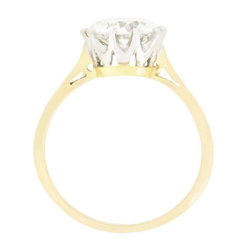 This timeless solitaire centres around a mesmerising 2.00 carat, old cut diamond. The diamond has a colour of I to J and clarity of VS1 and is claw set into an open platinum collet. A simple band of 18 carat yellow gold completes the ring, keeping