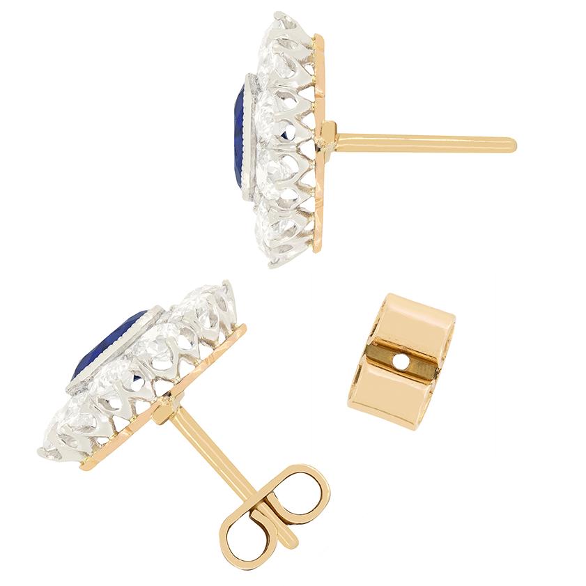 These stunning Edwardian earrings feature a pair of unheated sapphires surrounded by old cut diamonds. The sapphires each weigh 1.00 carat a piece and are an intense blue colour. Enveloping each sapphire, the halo of diamonds total 1.50 carat, with