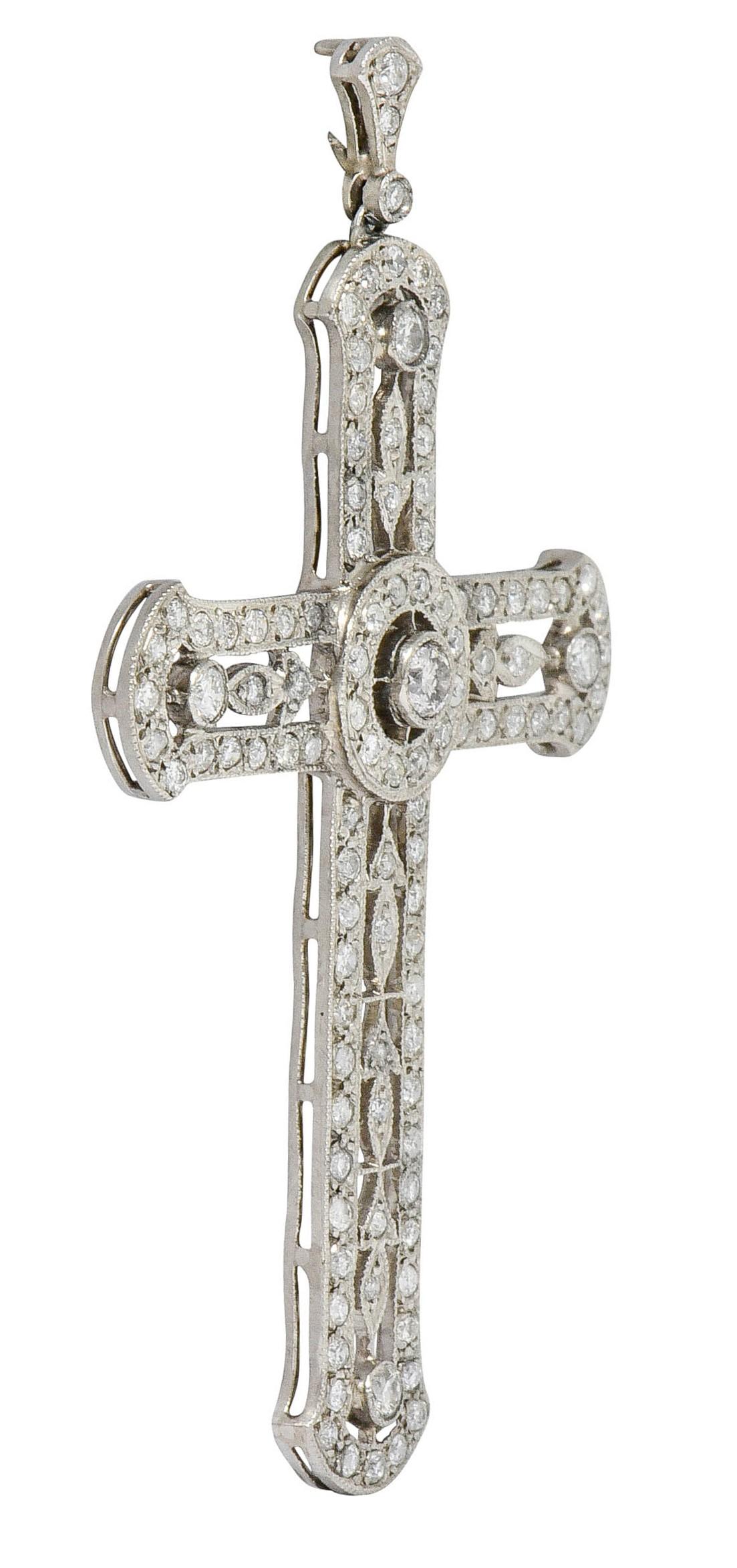 Large cross pendant features a circular center with pierced foliate details accented by milgrain

Set throughout by round brilliant and transitional cut diamonds; bead and bezel set

Weighing in total approximately 2.05 carats with H to K color and
