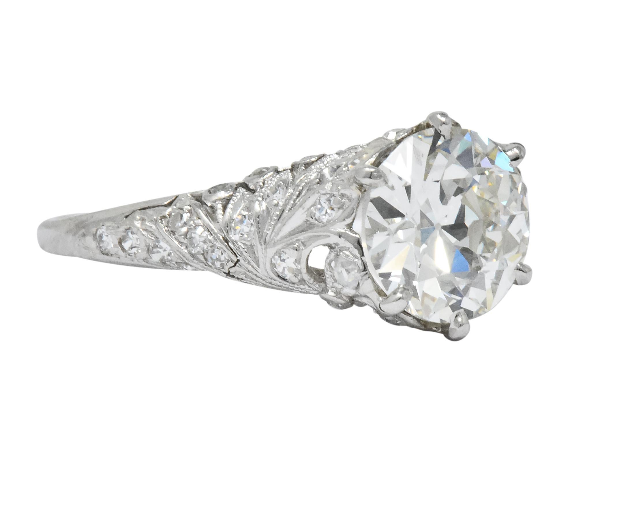 Centering a transitional cut diamond weighing 2.08 carts, K color and VS2 clarity

Claw set in a detailed Edwardian mounting with pierced stylized bow and floral motifs

Set throughout with single cut diamonds weighing approximately 0.15 carat