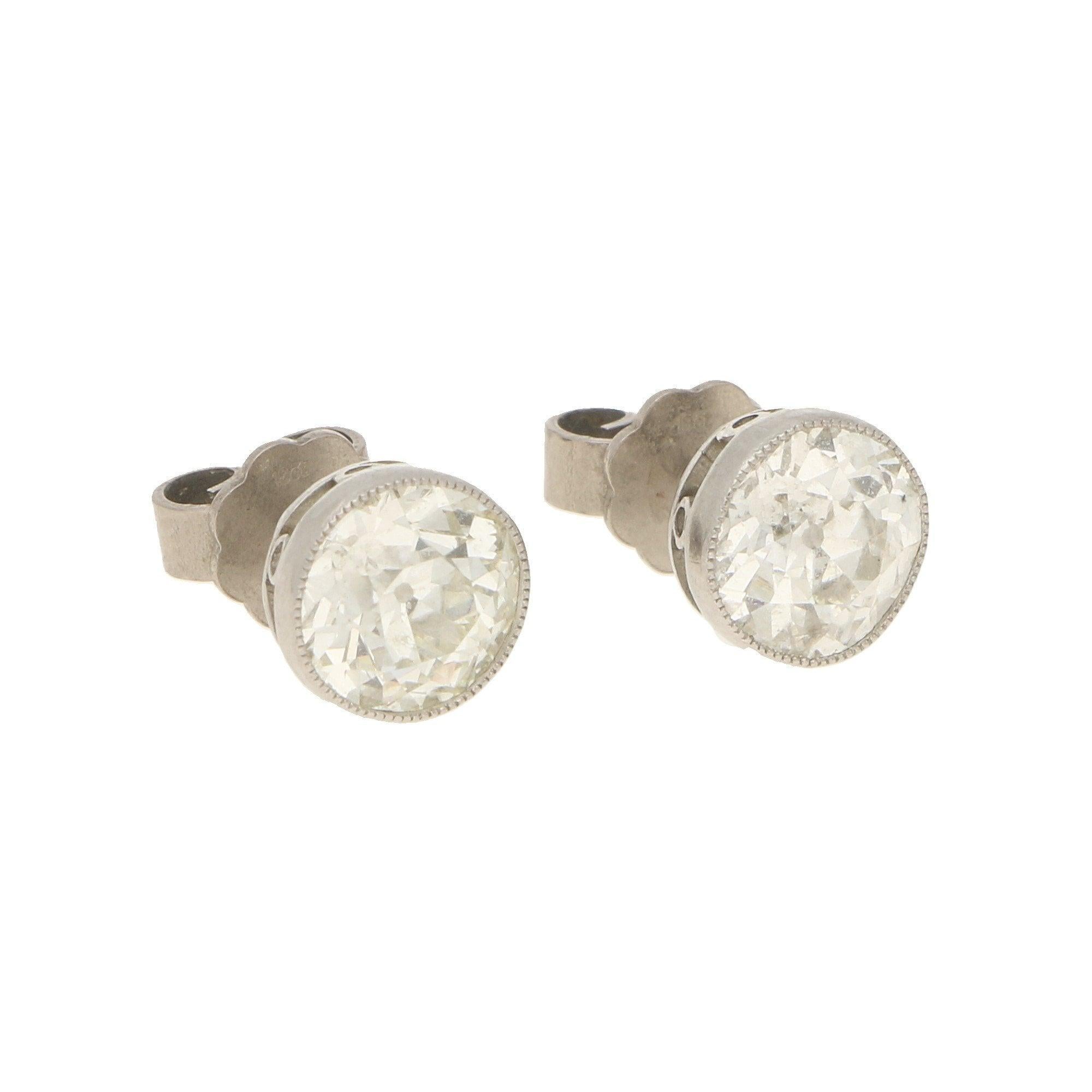 Diamonds approximately 2.50 carats in total, H/I colour, SI clarity.

A pair of Edwardian diamond stud earrings in platinum. Each earring features an Old Mine-cut diamond millegrain-set in an open-back platinum collet with an intricately pierced