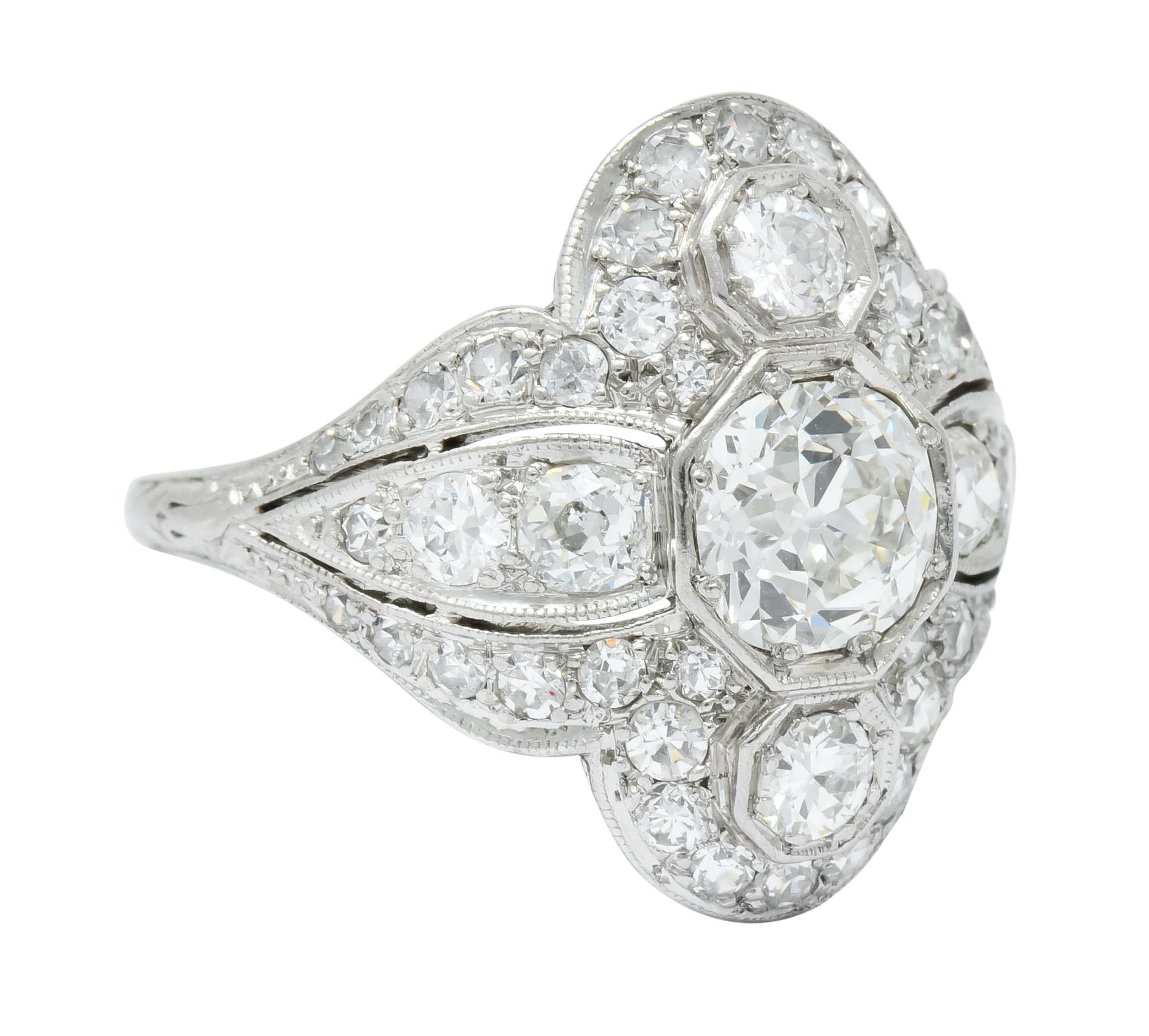 Centering three old European cut diamonds, bead set North to South, weighing in total 1.40 carats, I/J color and VS clarity

Surrounded by old European cut, single cut, and transitional cut diamonds weighing approximately 1.20 carats total, H to J