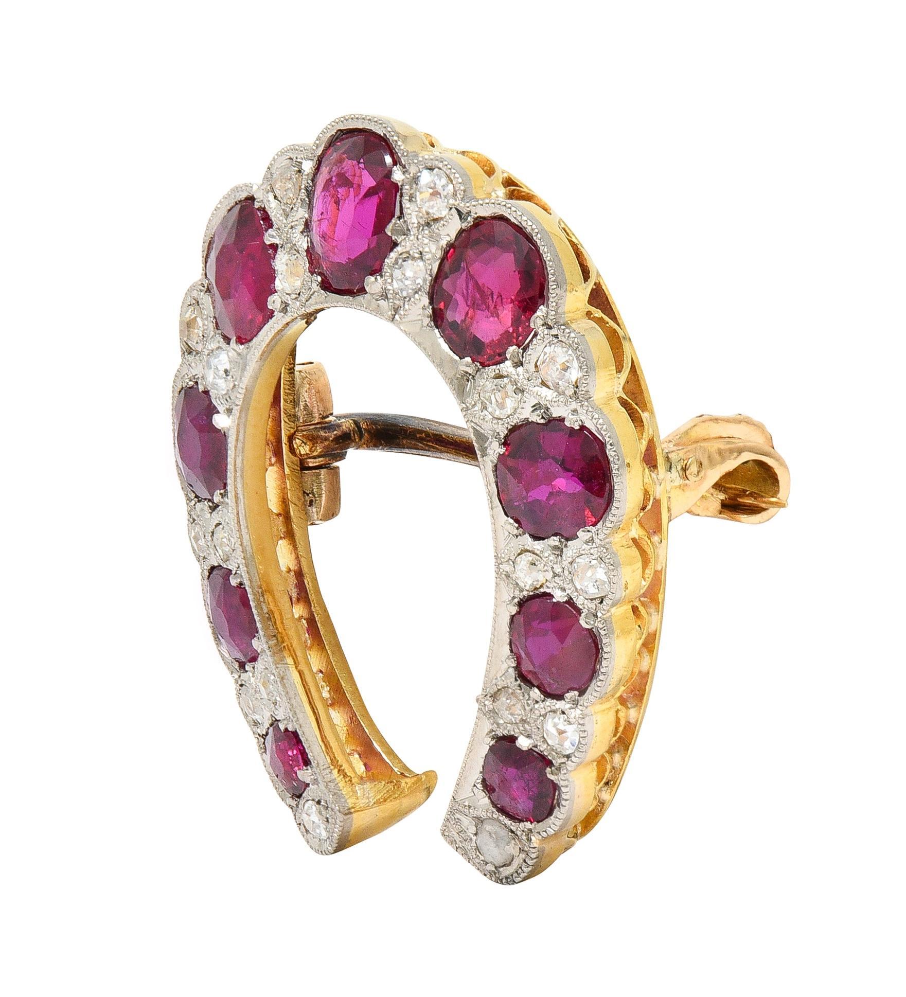 Designed as a platinum-topped horseshoe shape featuring bead set cushion cut rubies throughout
Weighing approximately 2.48 carats total - transparent medium red in color 
Alternating in pattern with bead set old single cut diamonds
Weighing