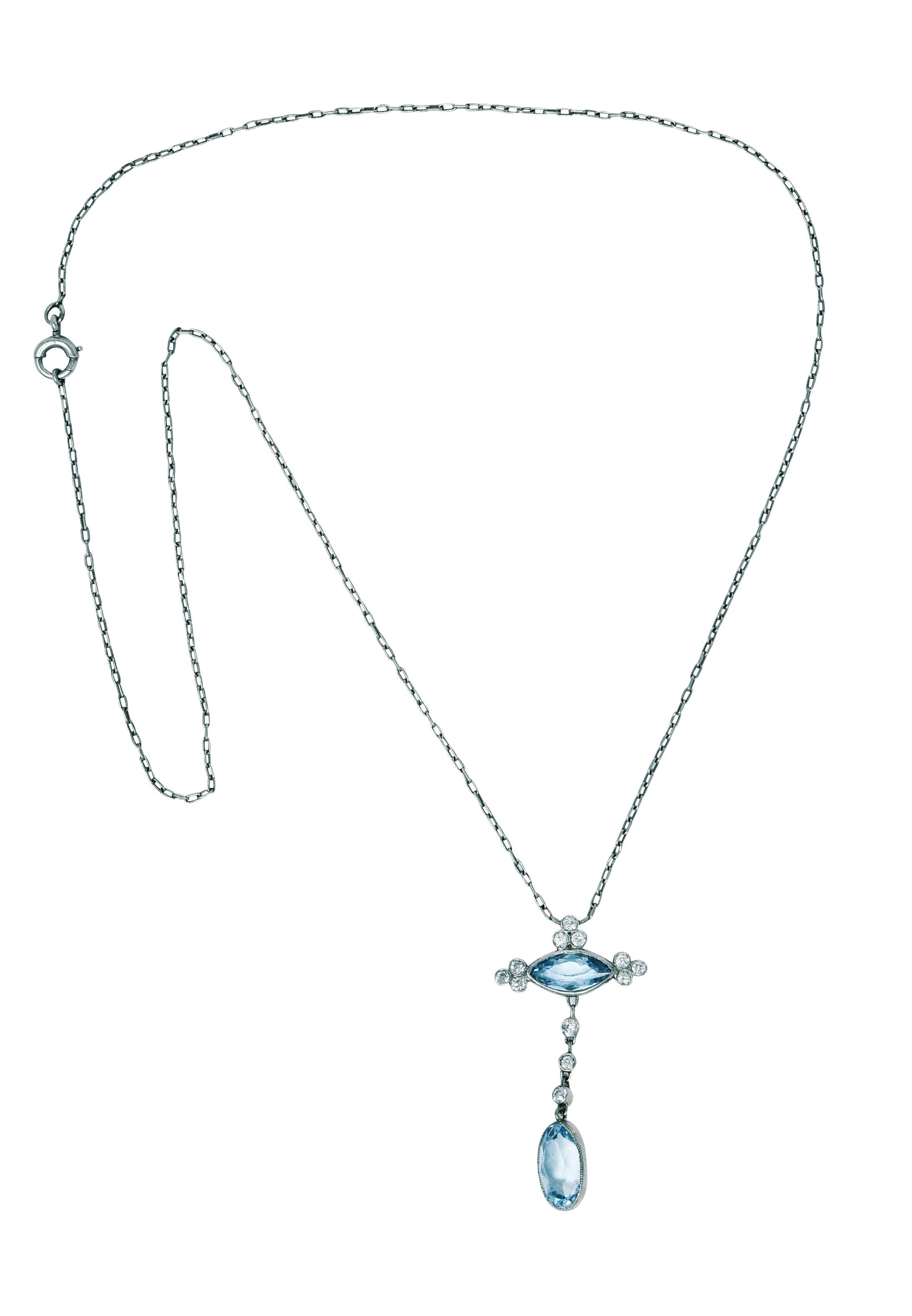 Delicately linked cable chain centers an articulated gemmed drop

Featuring a marquise and an oval cut aquamarine weighing in total approximately 2.40 carats

Bezel set and a well matched medium light greenish blue color

Accented by bezel set old
