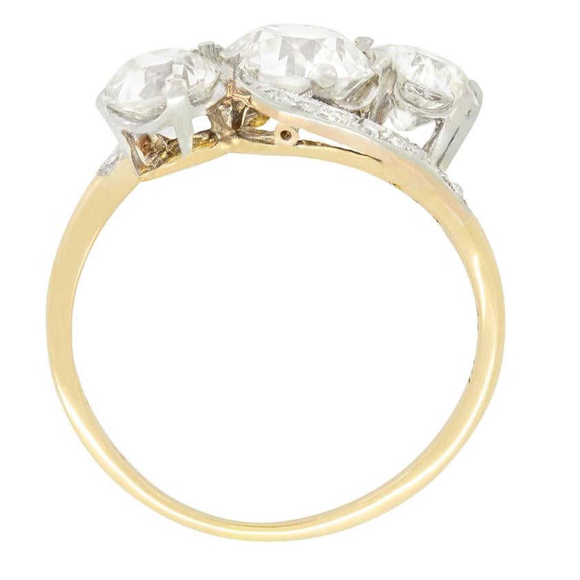 A trio of beautiful old cut diamonds are on display in this stunning Edwardian cross over ring. The middle of the three is the biggest at 1.40 carat with the flanking pair being 0.75 carat a piece. All three diamonds are of good quality at G to H in