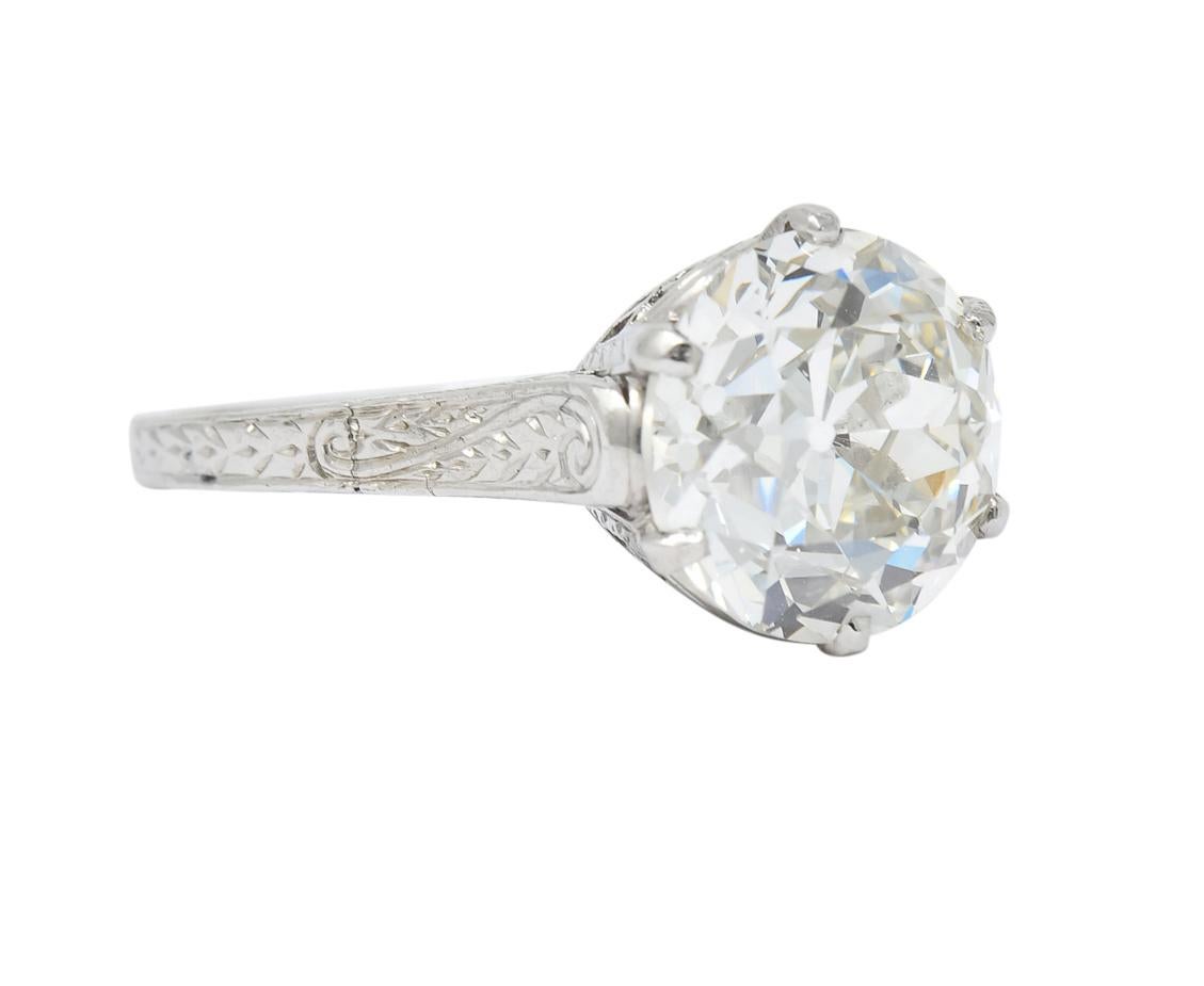 Centering an old European cut diamond weighing 3.14 carat, K color and VS1 clarity

In a six prong mount with detailed pierced gallery and engraved platinum shoulders  

Tested as platinum

Circa 1915

Ring Size: 4 3/4 & Sizable 

Top measures 10.0