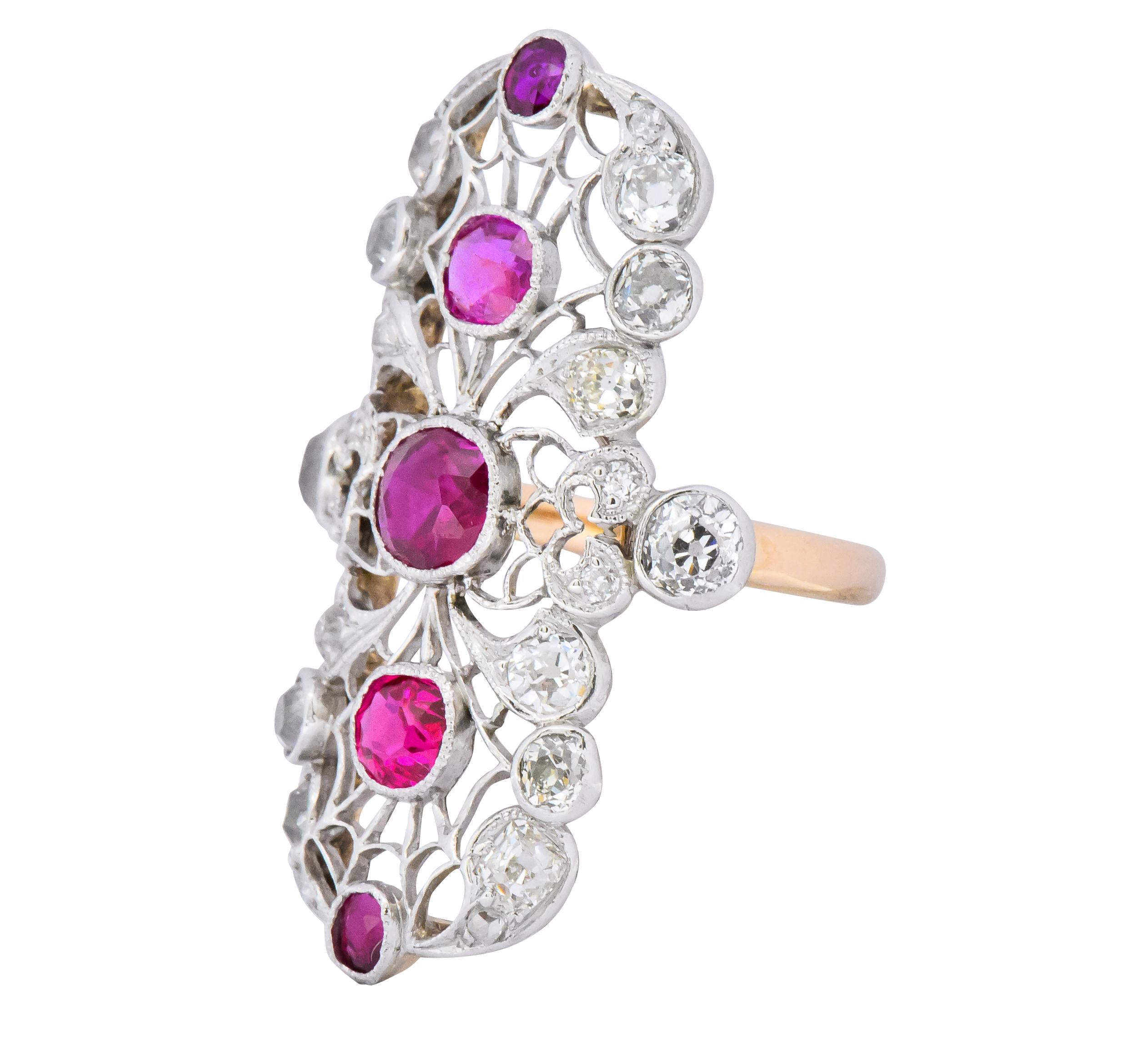 North to South style dinner ring, intricately pierced in a lace-like pattern

Centering five bezel set cushion cut rubies weighing in total approximately 2.00 carats; slightly pinkish-red to red in color

Accented by old mine and Swiss cut diamonds