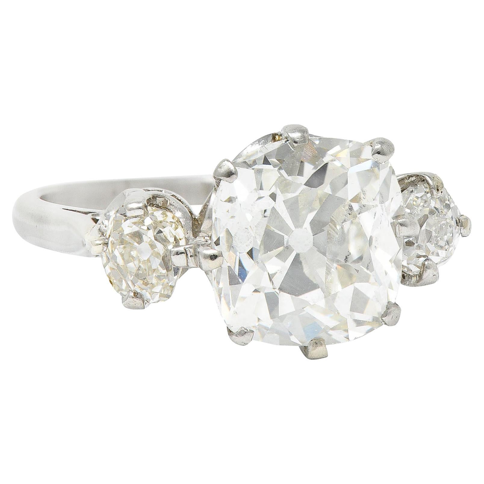 Edwardian 3.94 Carats Old Mine Diamond Platinum Three Stone Ring