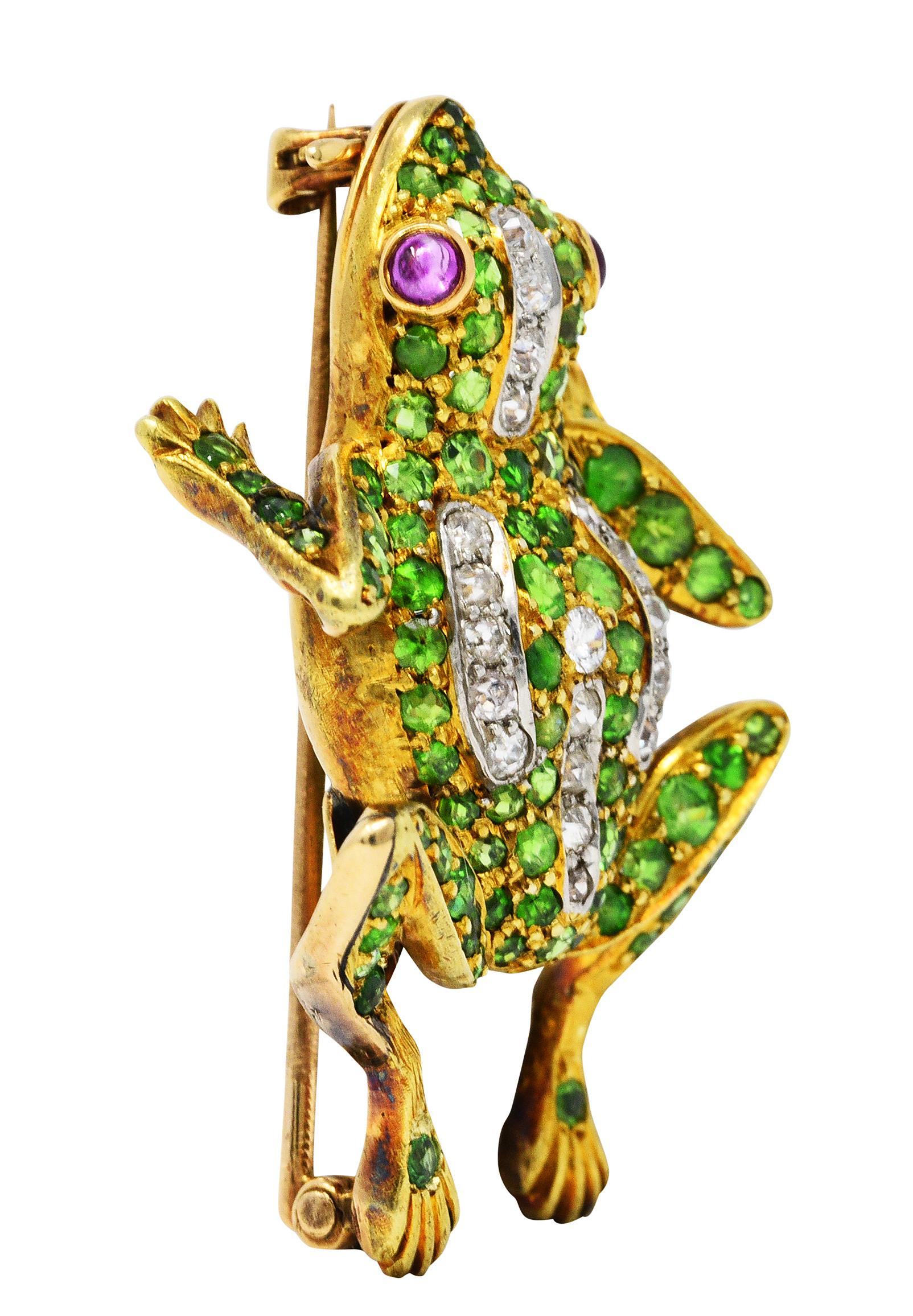 Brooch is designed as a dynamically formed frog

With ruby cabochon eyes, medium light purplish red, while weighing approximately 0.25 carat

Platinum areas are bead set with old European cut diamonds

Weighing in total approximately 0.50 carat with