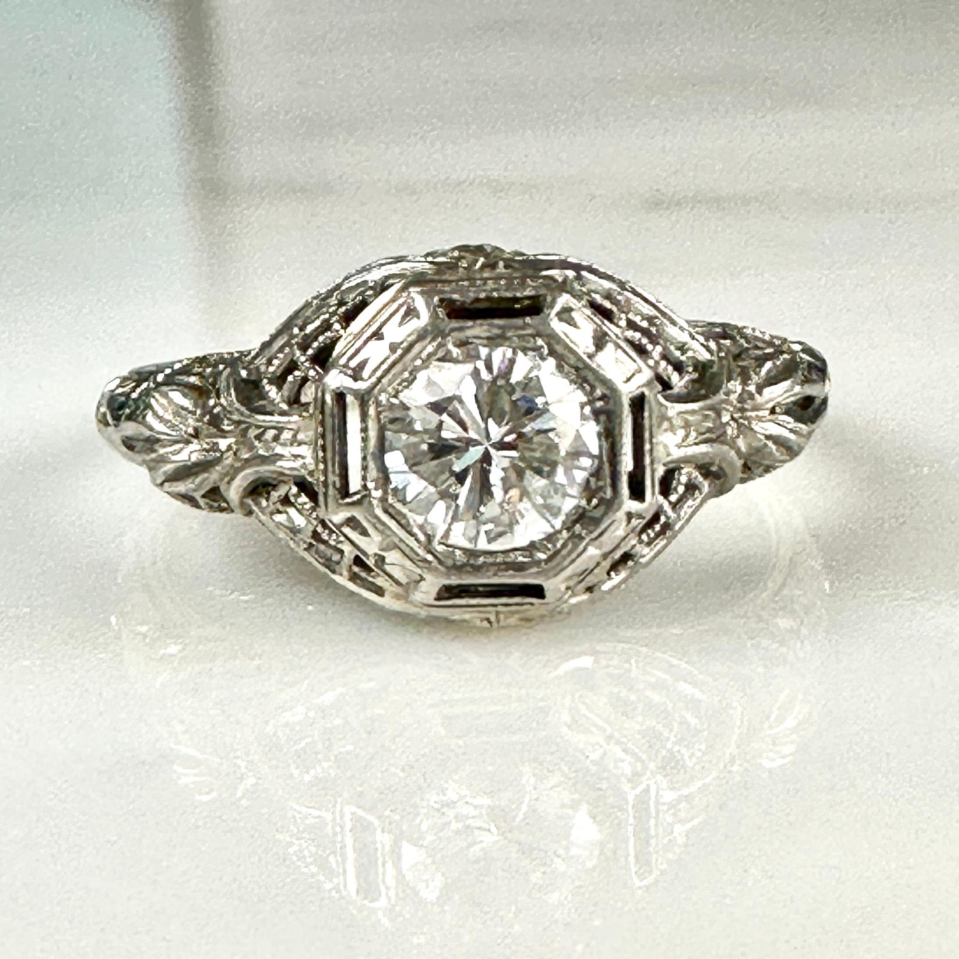 Details:
Beautiful delicate Edwardian 18K white gold filigree & diamond ring—would make a lovely wedding ring! The diamond is .50ct, and is set in a very detailed lacy filigree. The filigree is in amazing condition. The ring has a sweet engraving