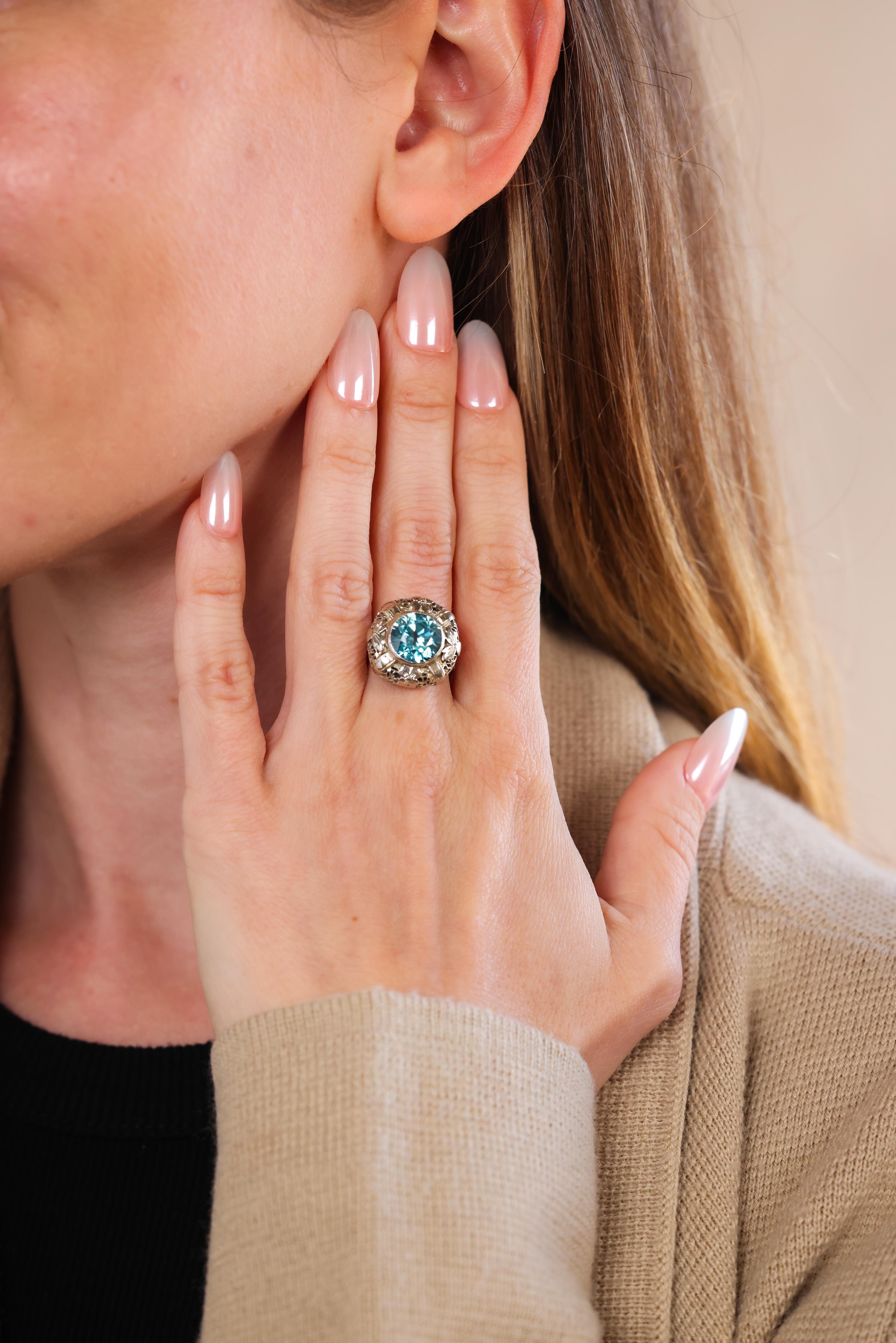 round cut blue zircon weighing approximately 5.15 carat 
14k white gold filigree design
Edwardian circa 1910s
ring size 6-1/2 and can be resized 
6.3 grams 

Step into the elegance of the Edwardian era with this exquisite ring, showcasing a stunning