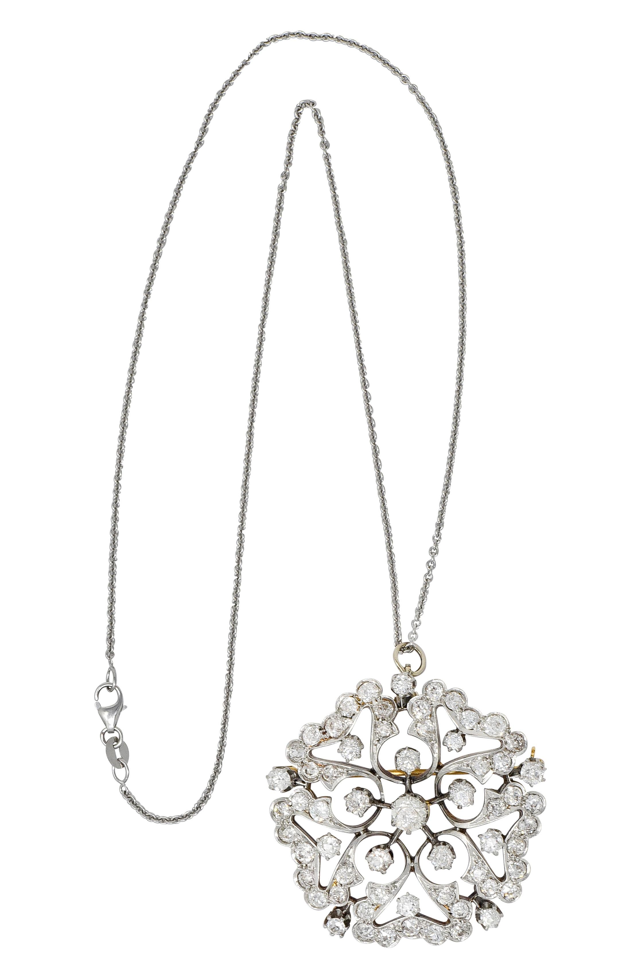 Centering a circular pendant designed as an intricately pierced radiating floral motif with scalloped petals

Set throughout by old mine and old European cut diamonds weighing approximately 6 carats total; H to K color with SI and I