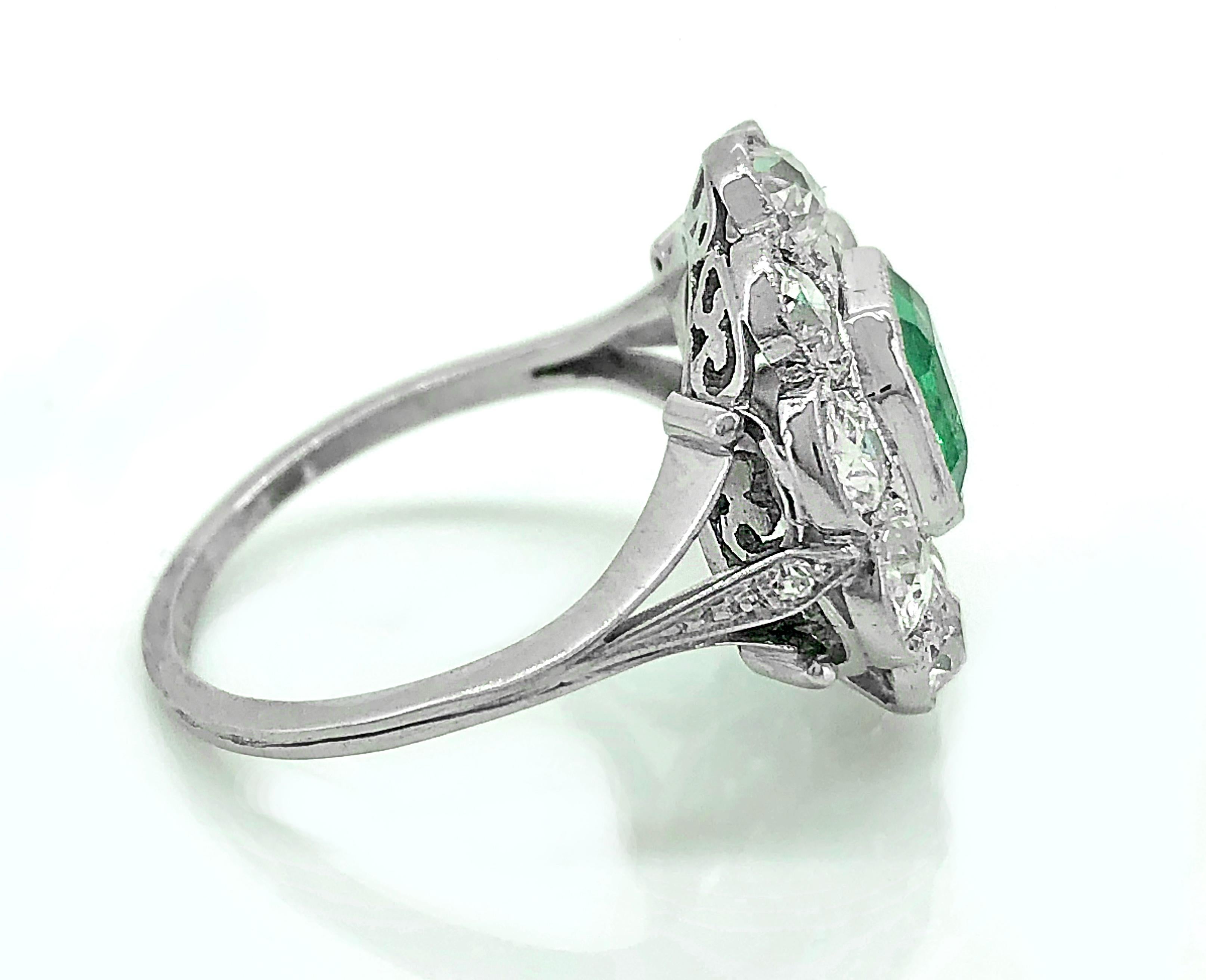 A striking Edwardian emerald and diamond Antique engagement or fashion ring featuring a natural antique square cut green emerald weighing .75ct. Apx. The emerald is accented with 1.00ct. Apx. T.W. of old European and single cut diamonds with SI1-I1
