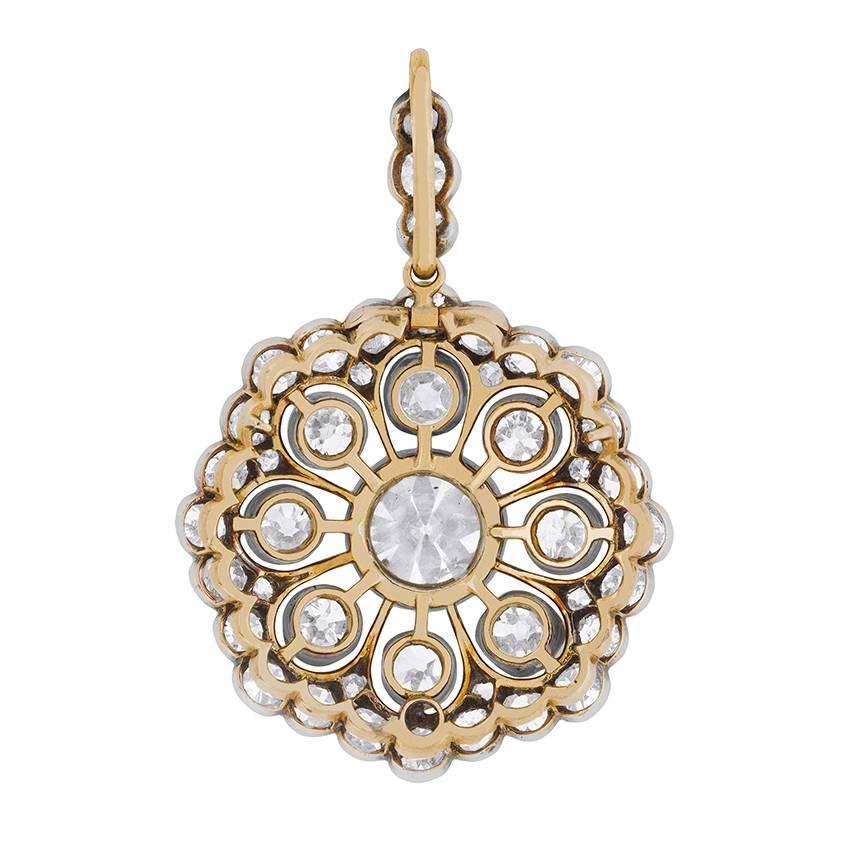 This exquisite Edwardian era jewel can be worn either as a pendant or as a brooch, and it comes in its original antique box.

It centres a superb 2.75 carat old European cut diamond at the centre of eight ‘petals’, each punctuated with an old cut