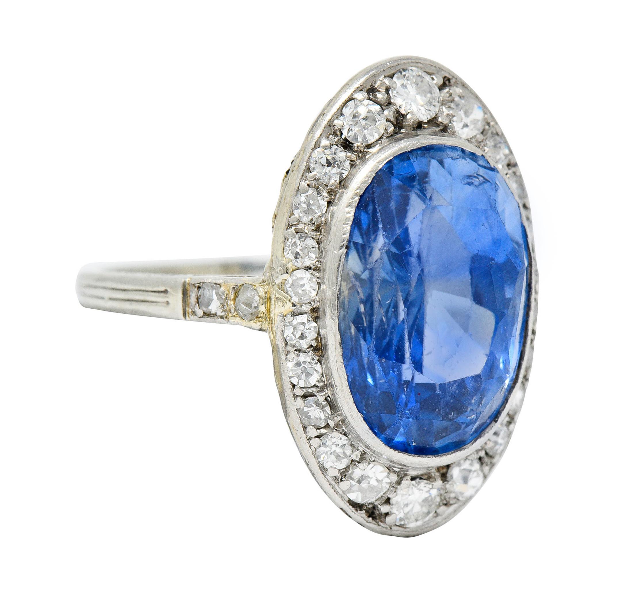 Centering a bezel set mixed oval cut Ceylon sapphire weighing approximately 7.84 carats

Transparent and medium violetish blue in color with no indications of heat - Sri Lankan in origin

Surrounded by old European, single, and round brilliant cut
