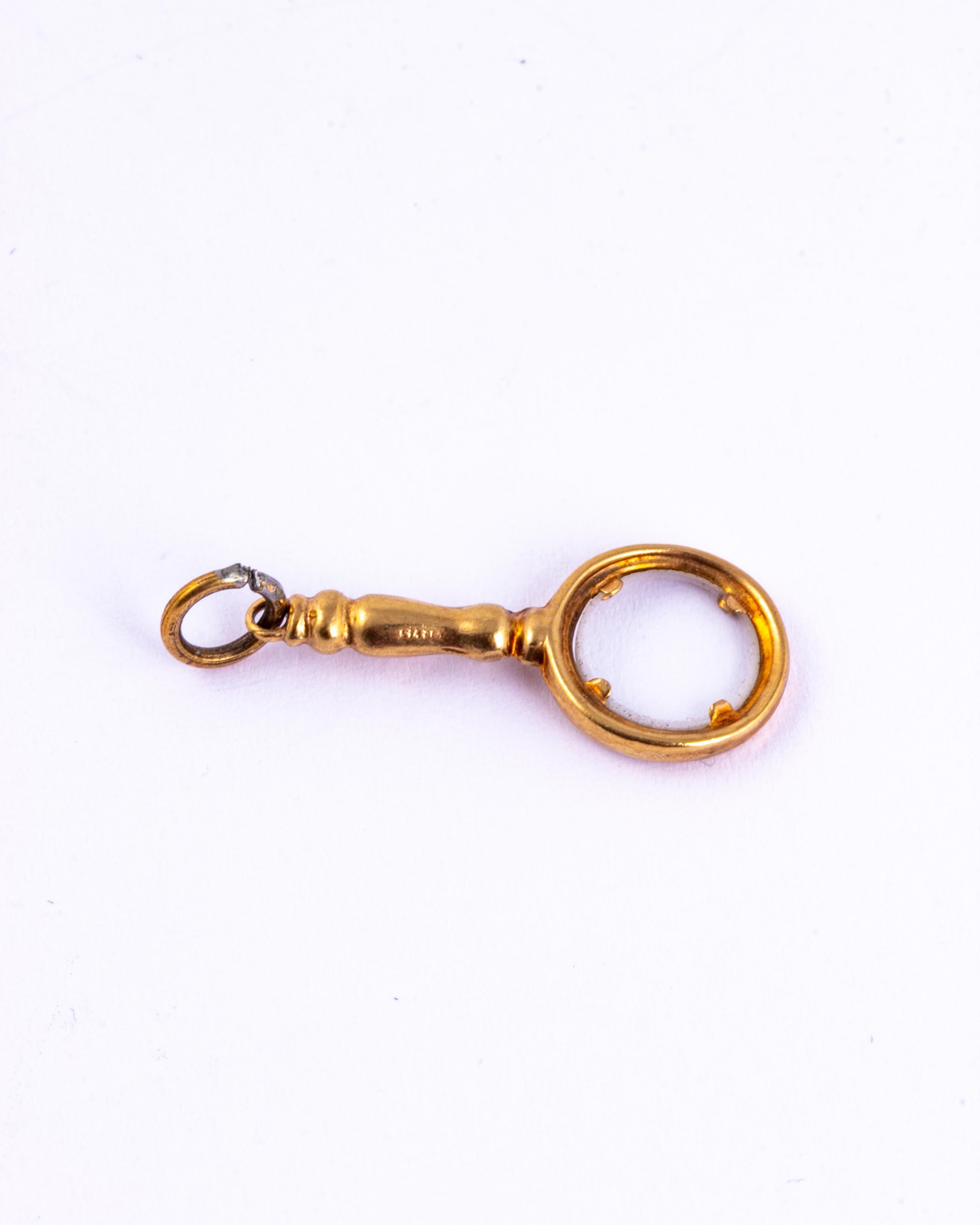 This pendant is a magnifying glass that actually works! It is so delicate and sweet and is modelled in 9ct gold. 

Length Including Loop: 25mm

Weight: 0.62g