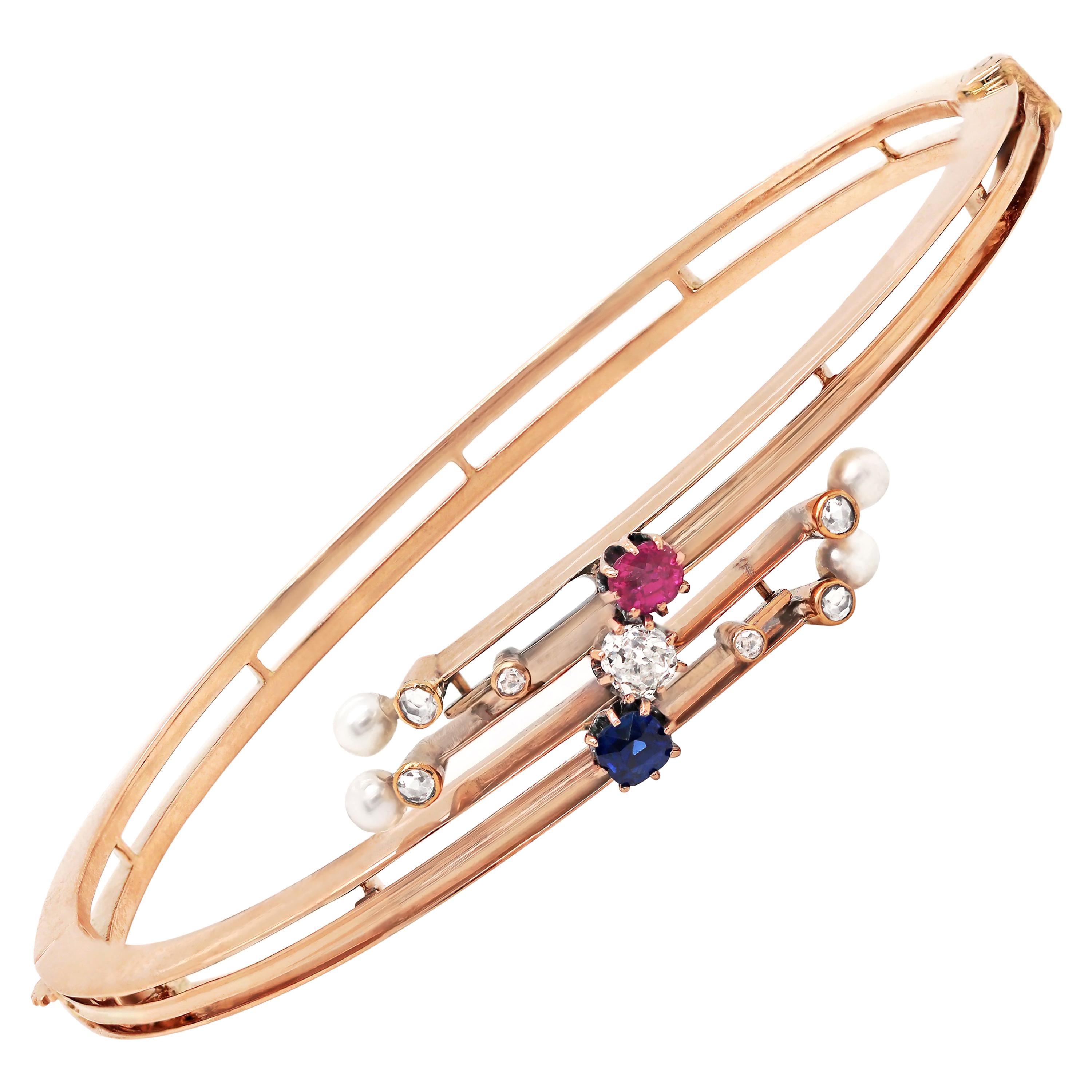 Edwardian 14 Carat Rose Gold Diamond, Sapphire, Ruby and Pearl Bangle, c.1900 For Sale