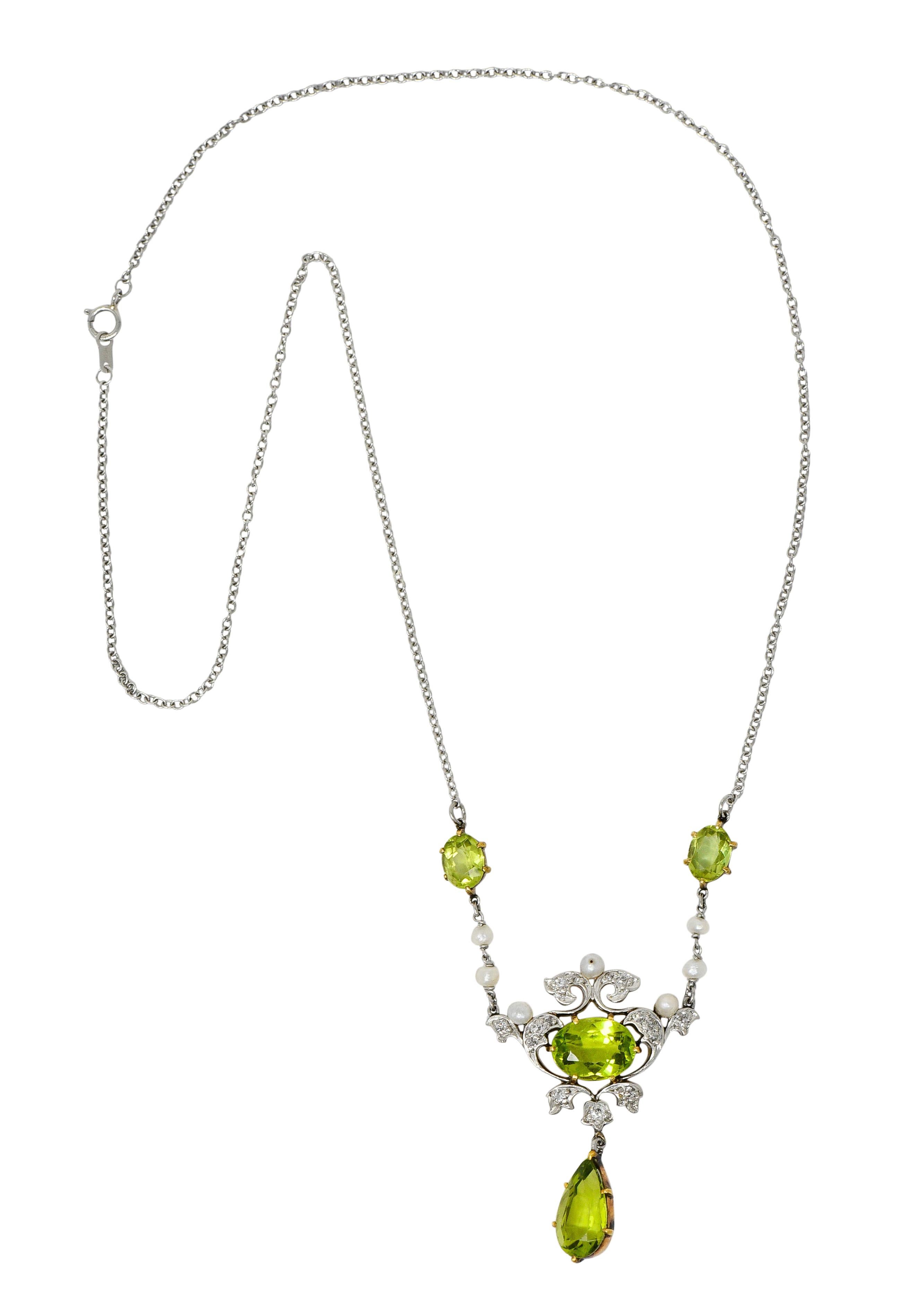 Cable chain necklace with a scrolled foliate center station accented by 3.0 mm freshwater natural pearls

Bead set throughout with old European cut diamonds weighing approximately 0.30 carat; eye-clean and white

Featuring bright yellowish-green