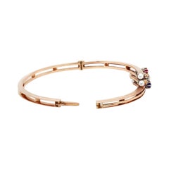 Edwardian 14 Carat Rose Gold Diamond, Sapphire, Ruby and Pearl Bangle, c.1900