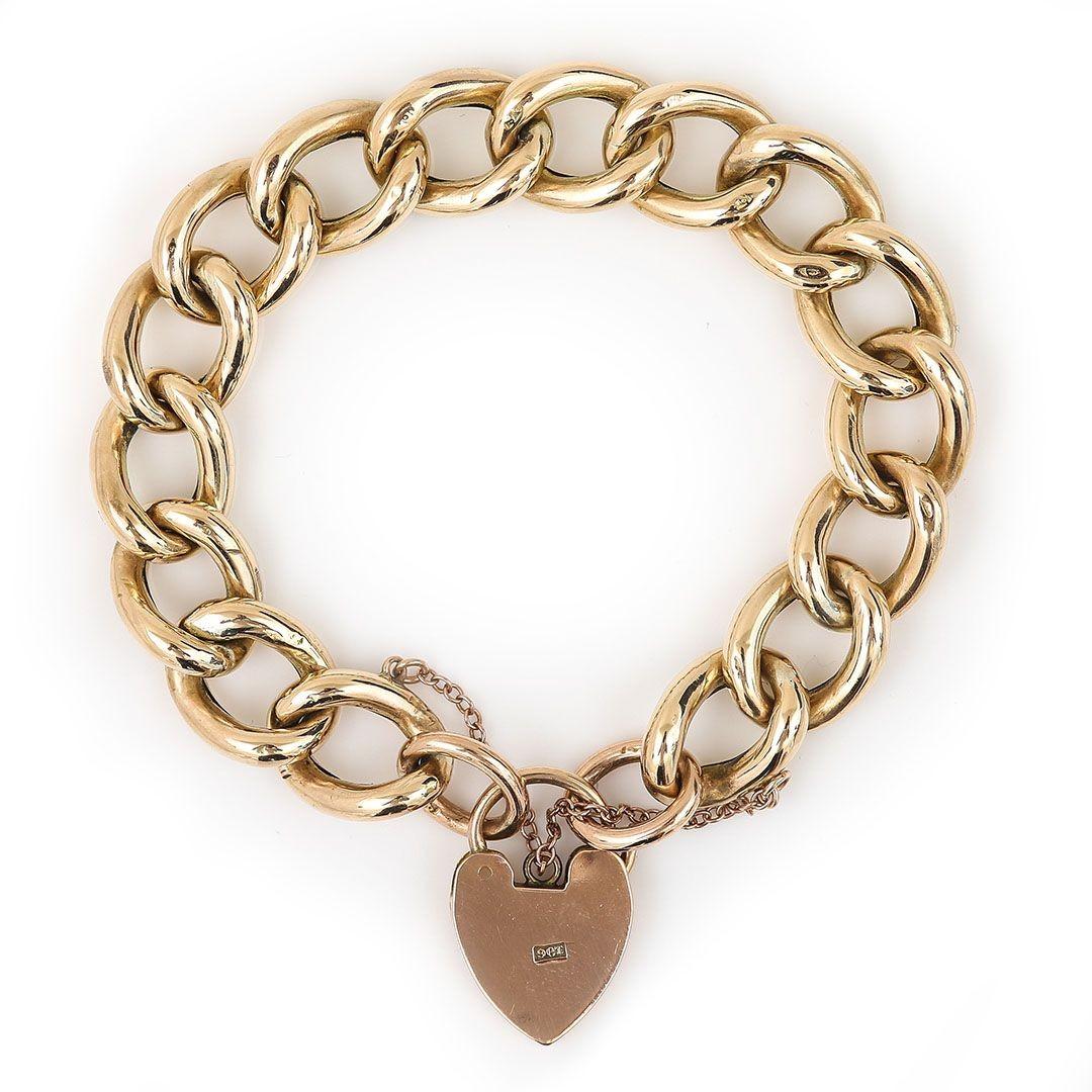 A super 9ct yellow gold curb link bracelet in fantastic condition that dates from the early part of the 20th century. Each link has been stamped ‘9CT’, also the attached padlock is marked similarly ‘9CT’. Each alternate link has been chased with a