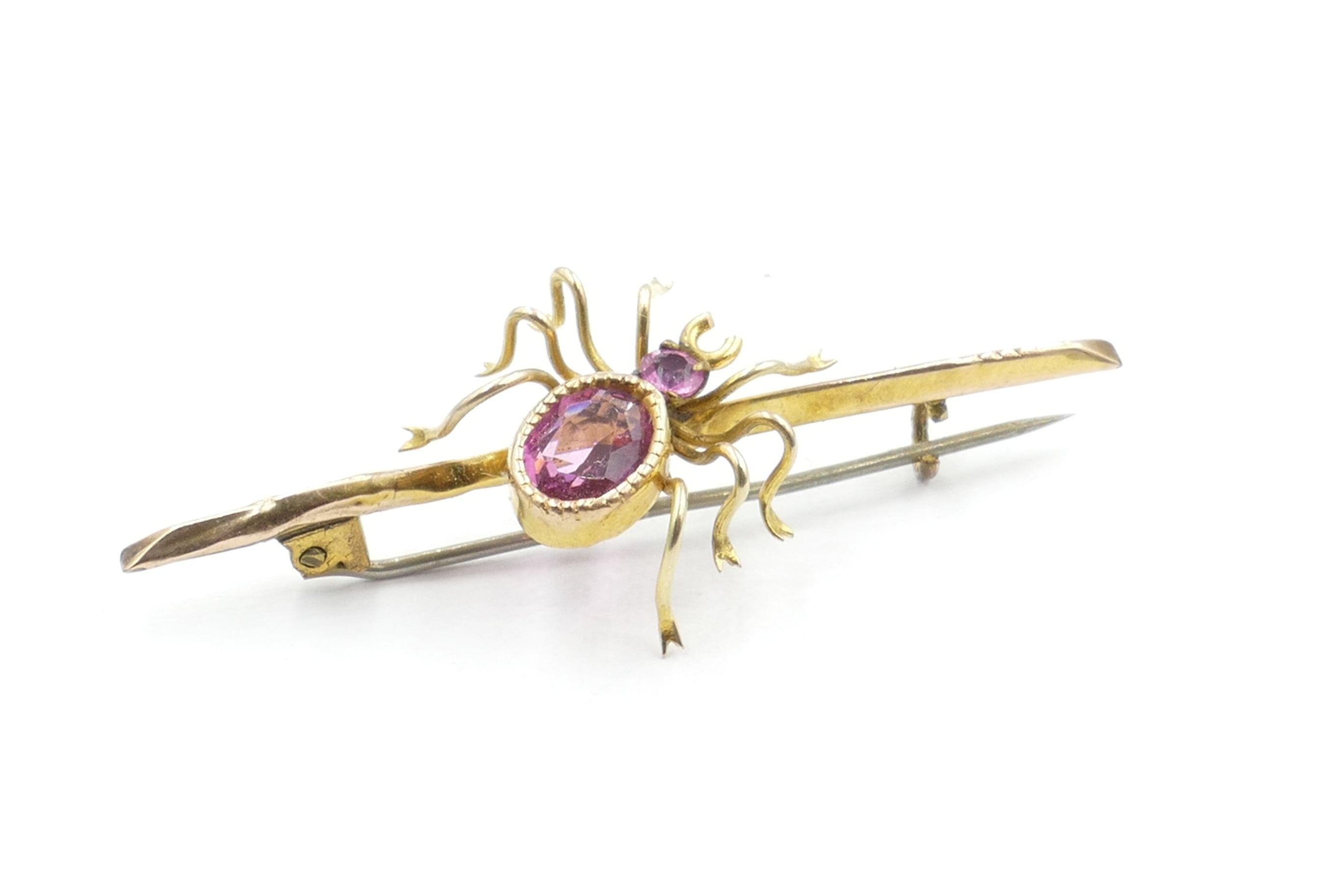 This gorgeous hand made 9ct Yellow Gold Spider Brooch is a real eye catcher.
It features an Oval Cut deep wine coloured reddish-purplish-pink Tourmaline, Millegrain - Bezel Set of approximately 0.7carats
 (6.9 X 5.2X 3.0mm) along with one round cut