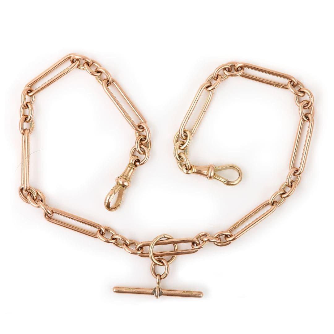 A solid, 9k rose gold antique Edwardian Albert chain with alternating trombone and round uniform links with a T-bar. Every link is stamped ‘9' '375'  the two swivel clips and t-bar are also marked. The t-bar is affixed to a large jump ring which