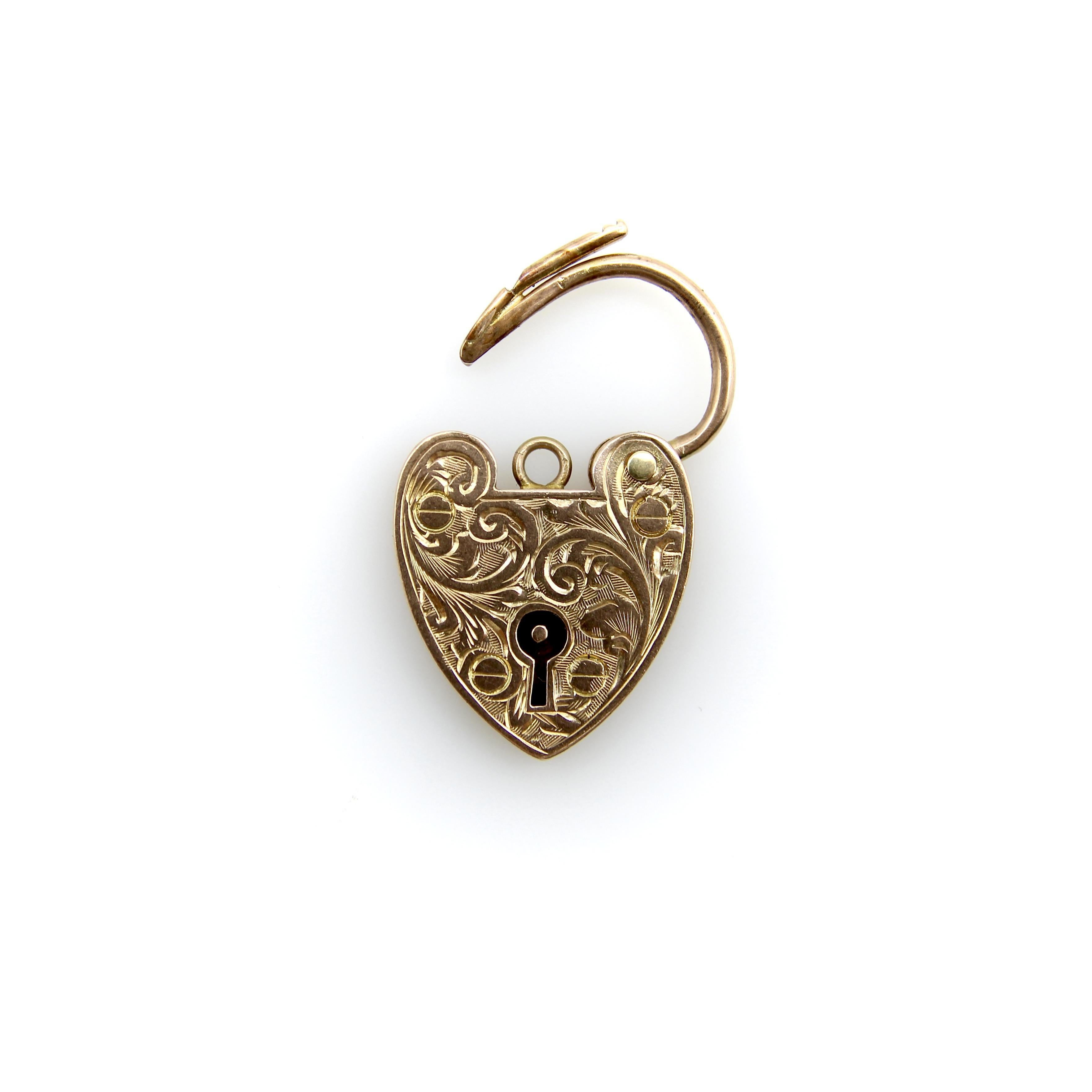 This Edwardian 9k gold heart padlock makes a perfect pendant or closure for a bracelet or necklace. It is hand engraved with a sweet scrolling foliate, and the padlock opens and closes with a nice click. The lock has adorable features that are meant