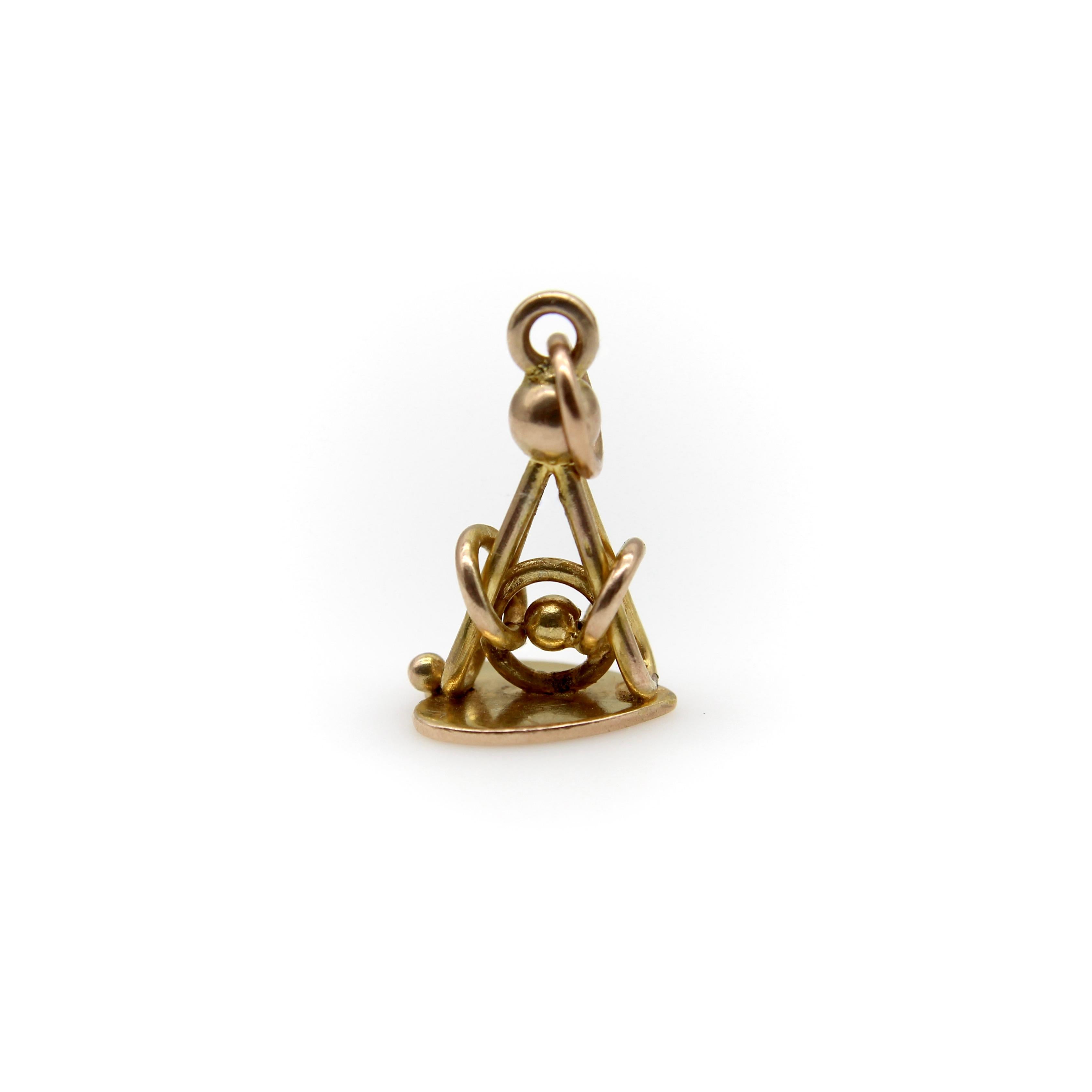 This Edwardian 9k gold fob presents as a beautiful, complex knot with bars that interlock around three circular links. At first glance, the piece appears to be a fob, but when it is turned on its side, a heart is revealed. The adorable heart,