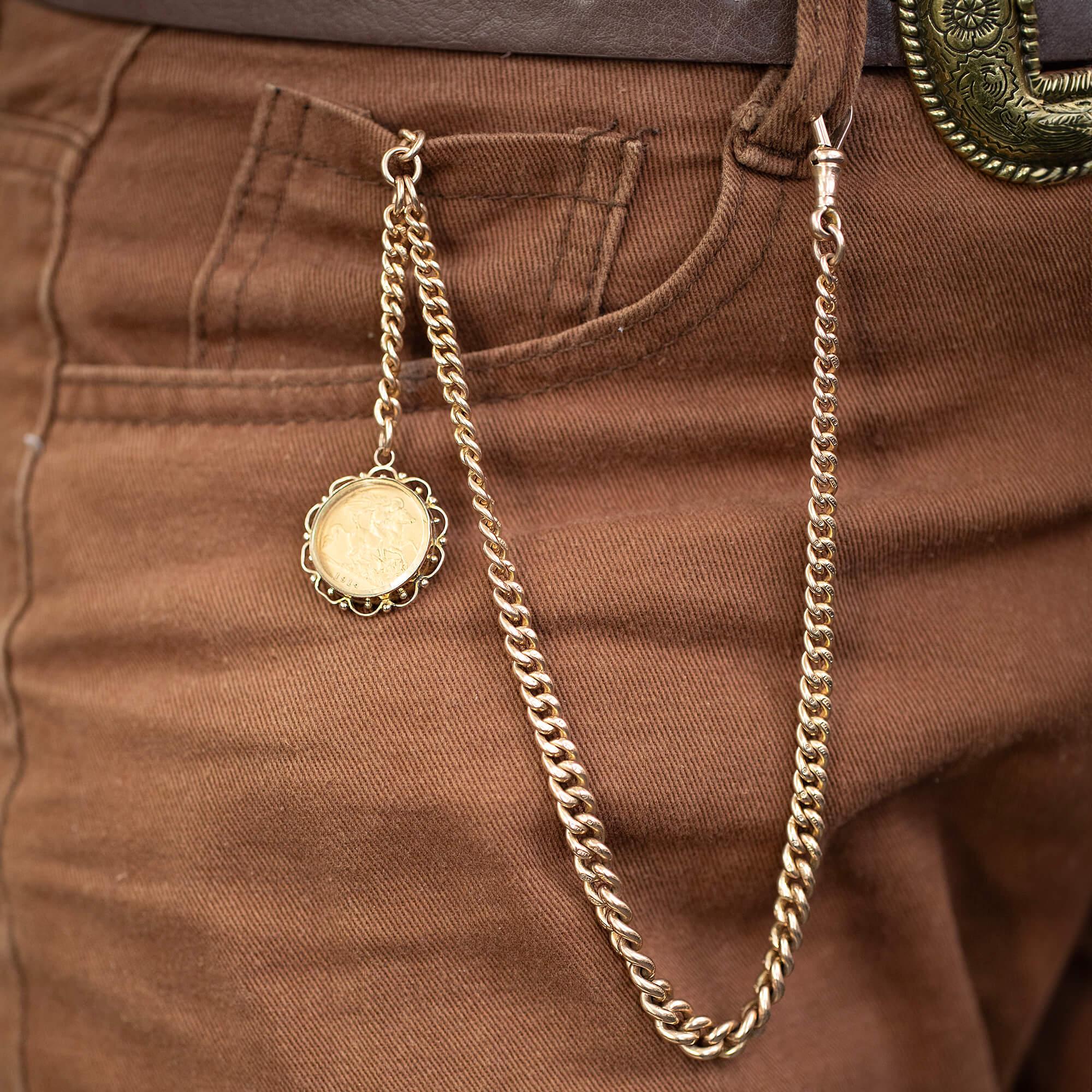 This solid 9k rose gold graduated albert watch chain is completely original with fob T-bar, extra chain drop and a swivel catch. Featuring a 1912 half sovereign set behind glass in a beautiful formed fine wire work surround setting.

Metal: 9k