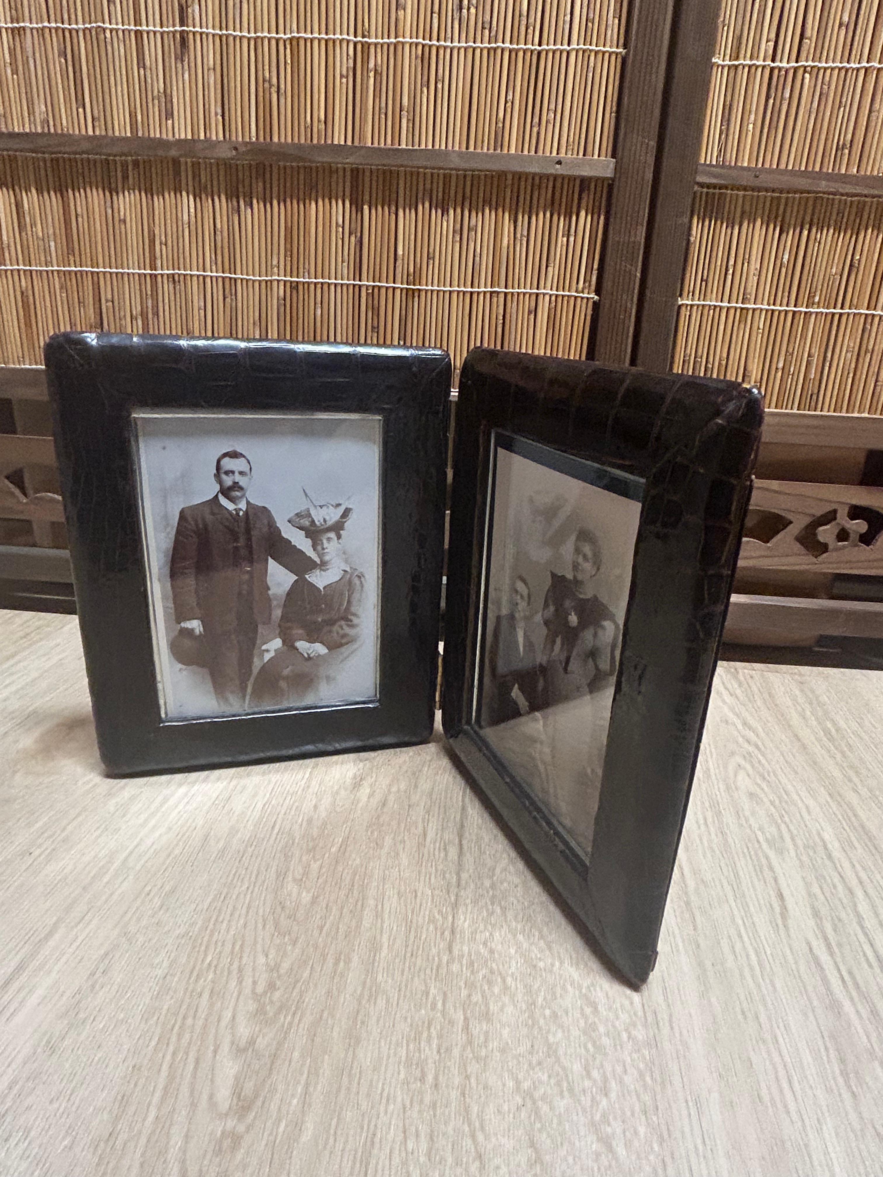 An Edwardian Alligator skin Double Photograph Frame, each frame containing an Edwardian husband and wife portrait, with dark green leather backing each frame. This Edwardian photograph frame is a deluxe model of its type, with Alligator skin on the