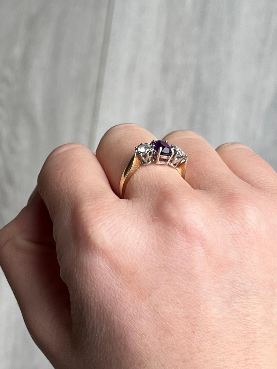The bright purple of this amethyst is complimented beautifully by the bright sparkling diamonds that sit either side. The amethyst measures approximately 75pts and the diamonds measure 20pts each. The stones are set in platinum and the rest of the