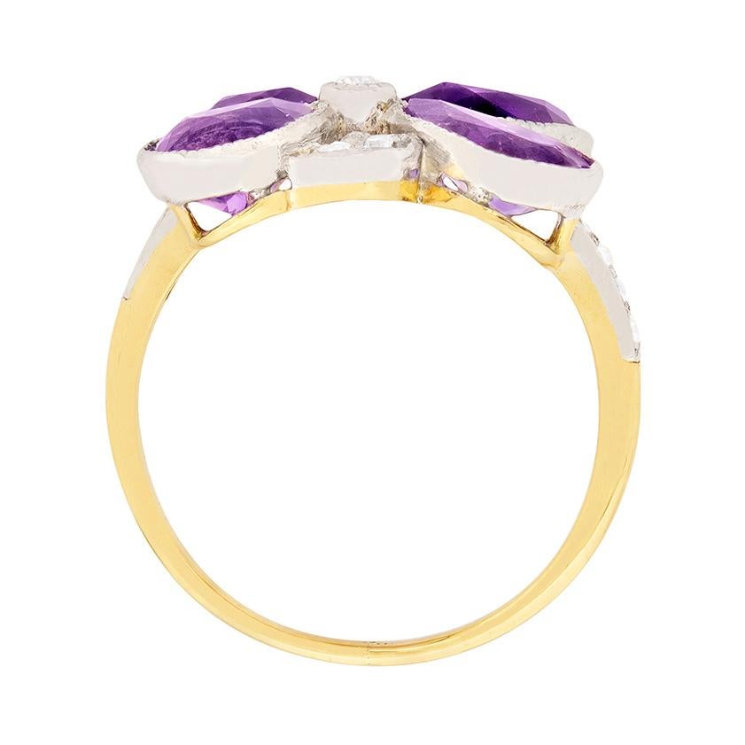 Dating to approximately 1910, this beautiful ring features four pear shaped amethysts. Two weigh 0.75 carat and two weigh 0.60 carat, bringing the total to 2.70 carat. The diamonds, which are old cuts, have a combined weight of 0.38 carat and are