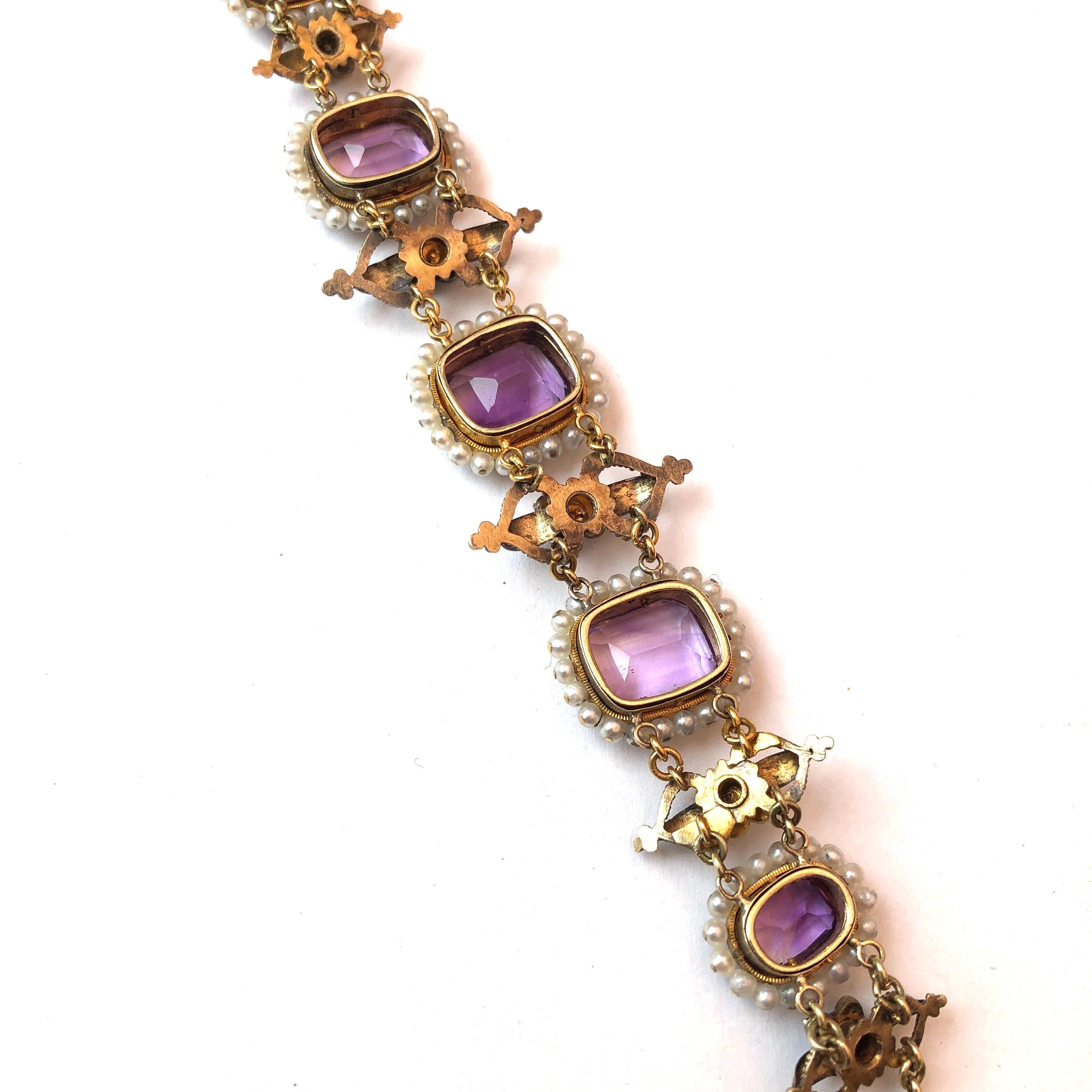 This fancy bracelet holds 6 larger Amethyst stones and in-between each one is a flower cluster of four smaller ones. Surrounding each larger stone is a halo of glossy pearls which really make the colour of the amethysts pop. The bracelet is modelled